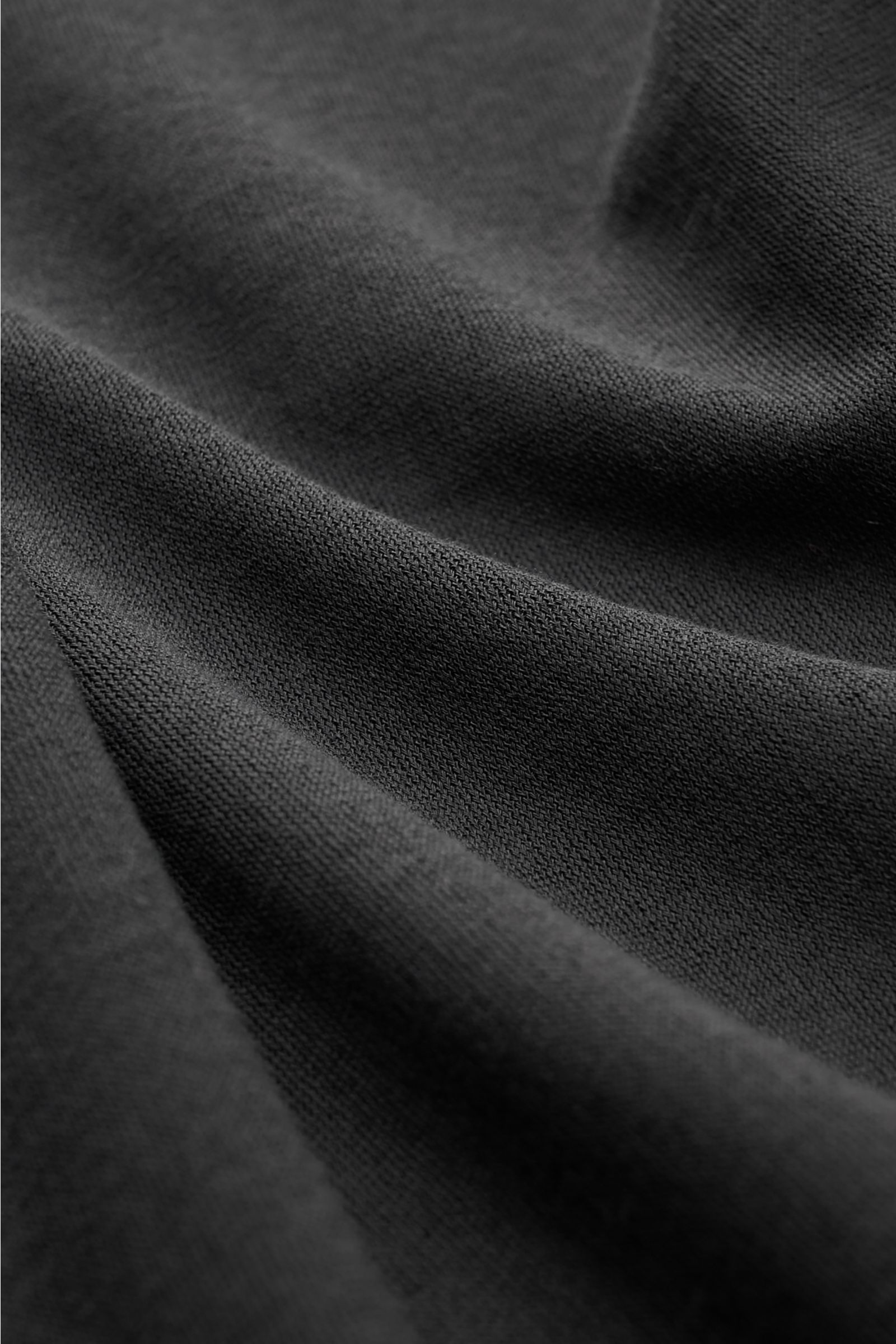 Close-up front view of BRAUN Hamburg Jersey long sleeve polo shirt anthracite fabric, showing slightly robust cotton jersey texture.

Description: Sporty style for the new season: BRAUN HAMBURG has processed pure cotton into comfortable jersey to make 