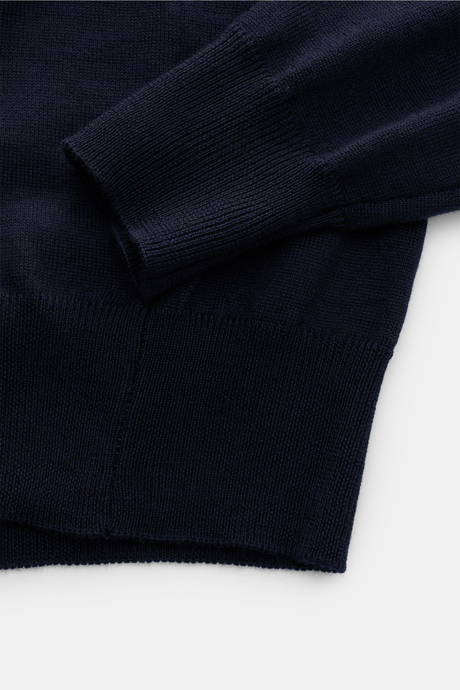 Close-up front view of Aurélien Merino knit polo navy sleeve and hem, showcasing fine knit, ribbed bands, and soft pure merino wool texture. Ideal for sophisticated casual looks: This knit polo has been made in Italy by AURÉLIEN from high-quality Cashwool