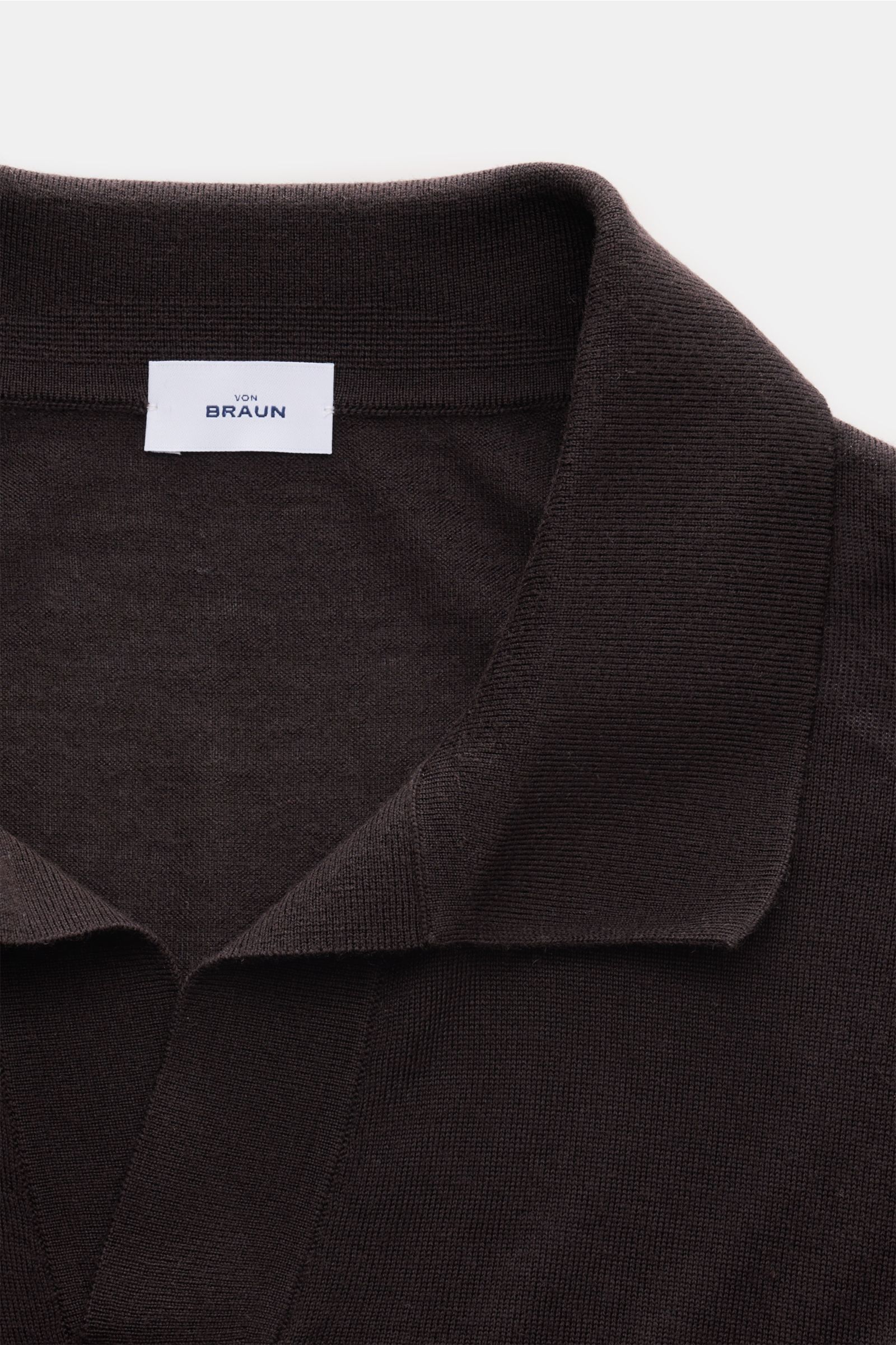 Close-up front view of von Braun Merino knit polo dark brown showing the open collar placket and fine knit texture.

An elegant basic for casual looks: This VON BRAUN knit polo with open collar placket is a casual alternative to a fine knit jumper or s