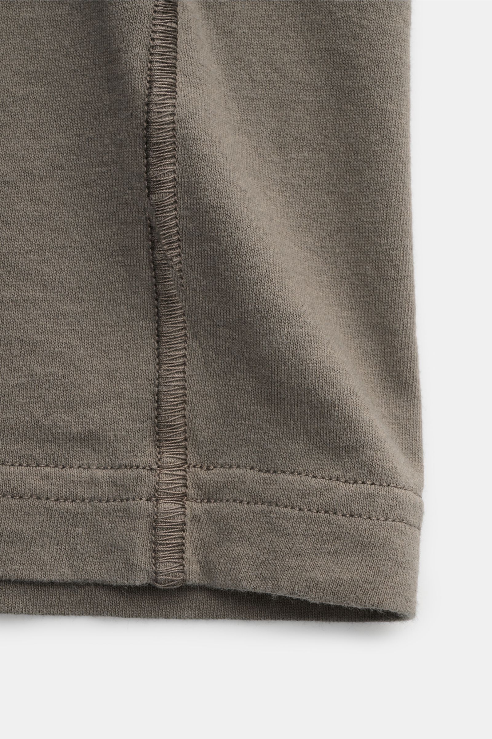 Close-up of the hem and overlock seam of the Stone Island Crew neck T-shirt grey-green, showing the soft organic cotton fabric from a flat lay perspective.

STONE ISLAND delivers an essential basic for your casual wardrobe with this relaxed T-shirt mad