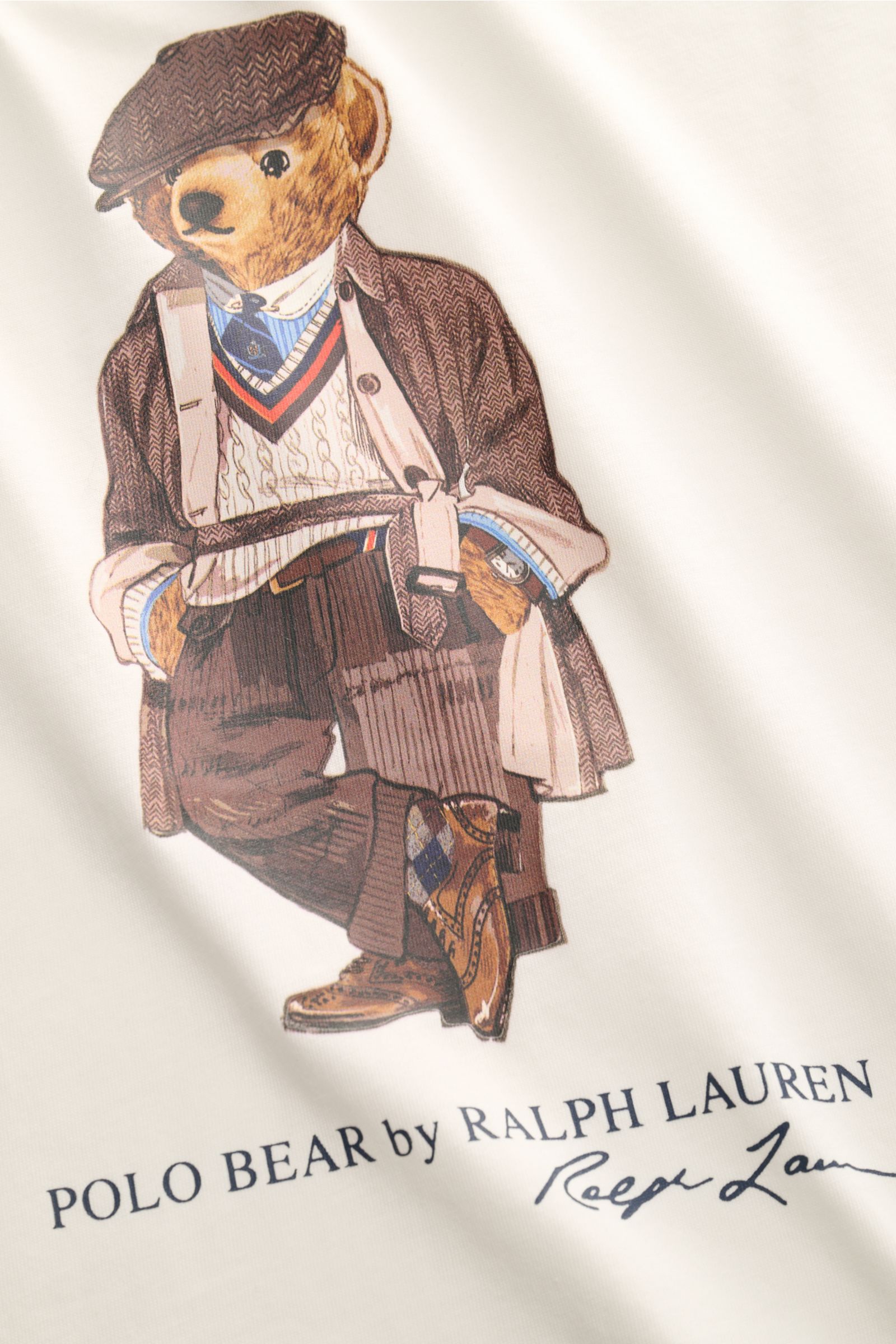 Nahaufnahme des Polo Ralph Lauren Rundhals-T-Shirts offwhite mit Polo-Bear-Print, Baumwolljersey, weichem Griff, Extra Slim Fit und Rundhalsausschnitt, frontal fotografiert.
