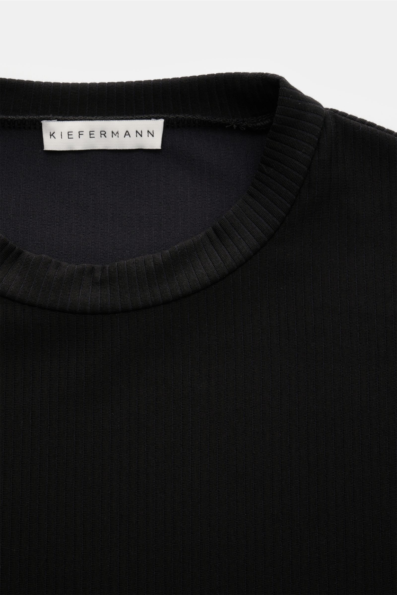 Kiefermann Crew neck T-shirt 'Wardeno' black shown from a top close-up perspective highlighting the rib knit fabric and collar. The 'Wardeno' T-shirt by KIEFERMANN is constructed entirely from a heavy, stretch viscose jersey in a rib knit, setting a ne