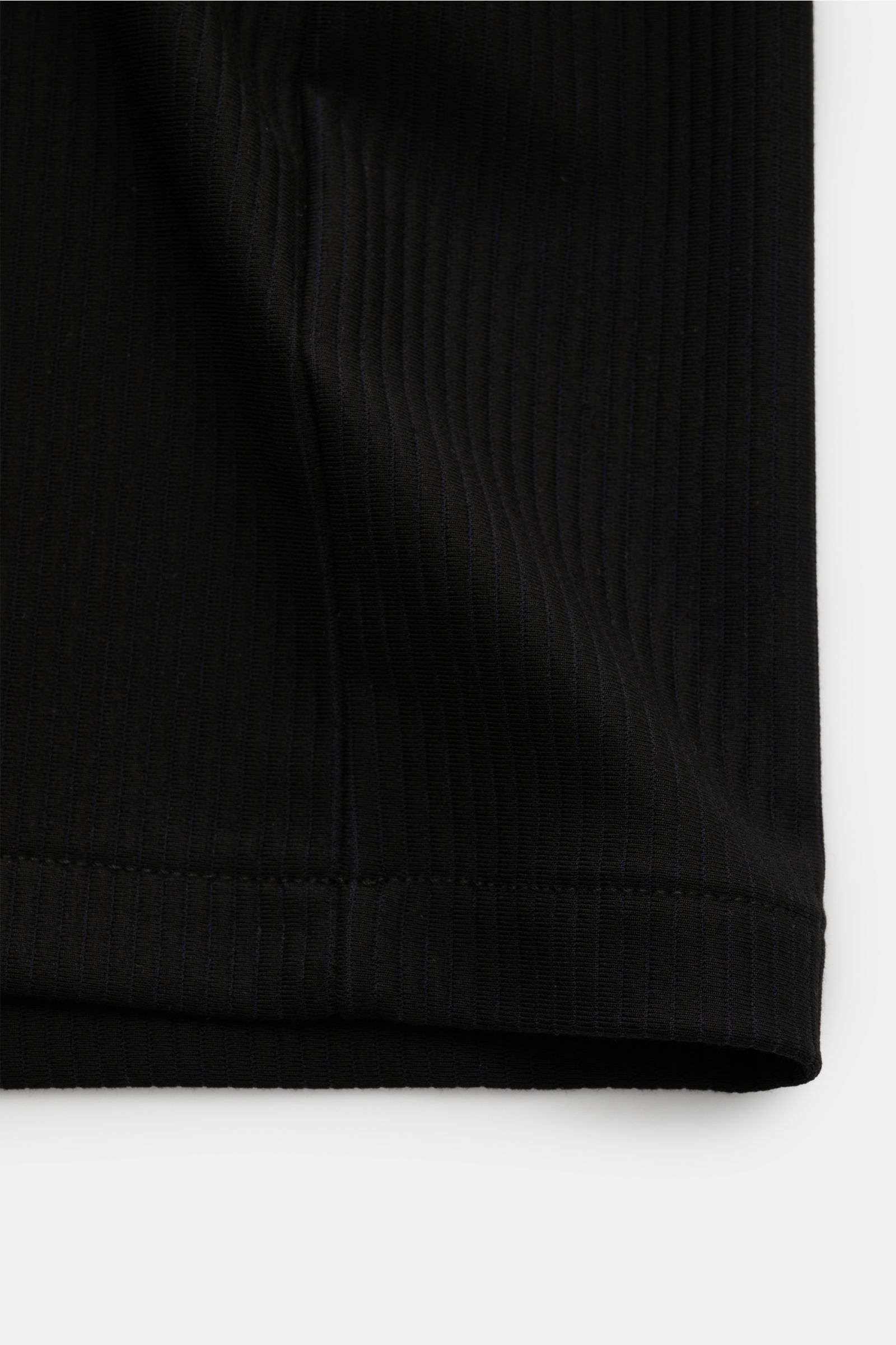 Close-up front-side view of the Kiefermann Crew neck T-shirt 'Wardeno' black showing rib knit texture and hem. The 'Wardeno' T-shirt by KIEFERMANN is constructed entirely from a heavy, stretch viscose jersey in a rib knit, setting a new standard for your 