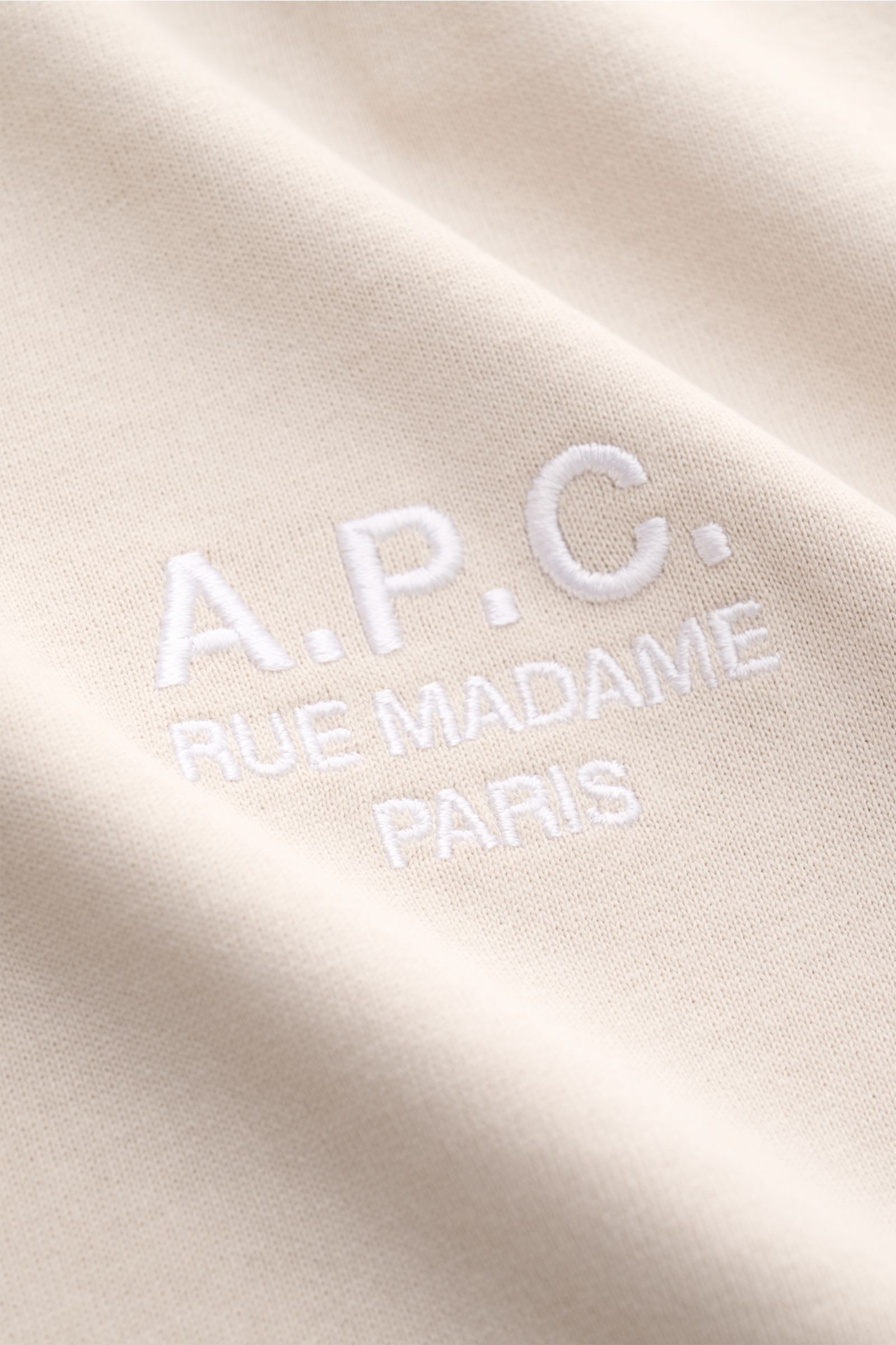 Close-up front view of A.P.C. Crew neck T-shirt 'Standard Rue Madame' beige showing white embroidered logo on soft pure cotton jersey fabric.

Clean, cool, A.P.C. – the T-shirt 'Standard Rue Madame' is the epitome of French understatement. In soft cott