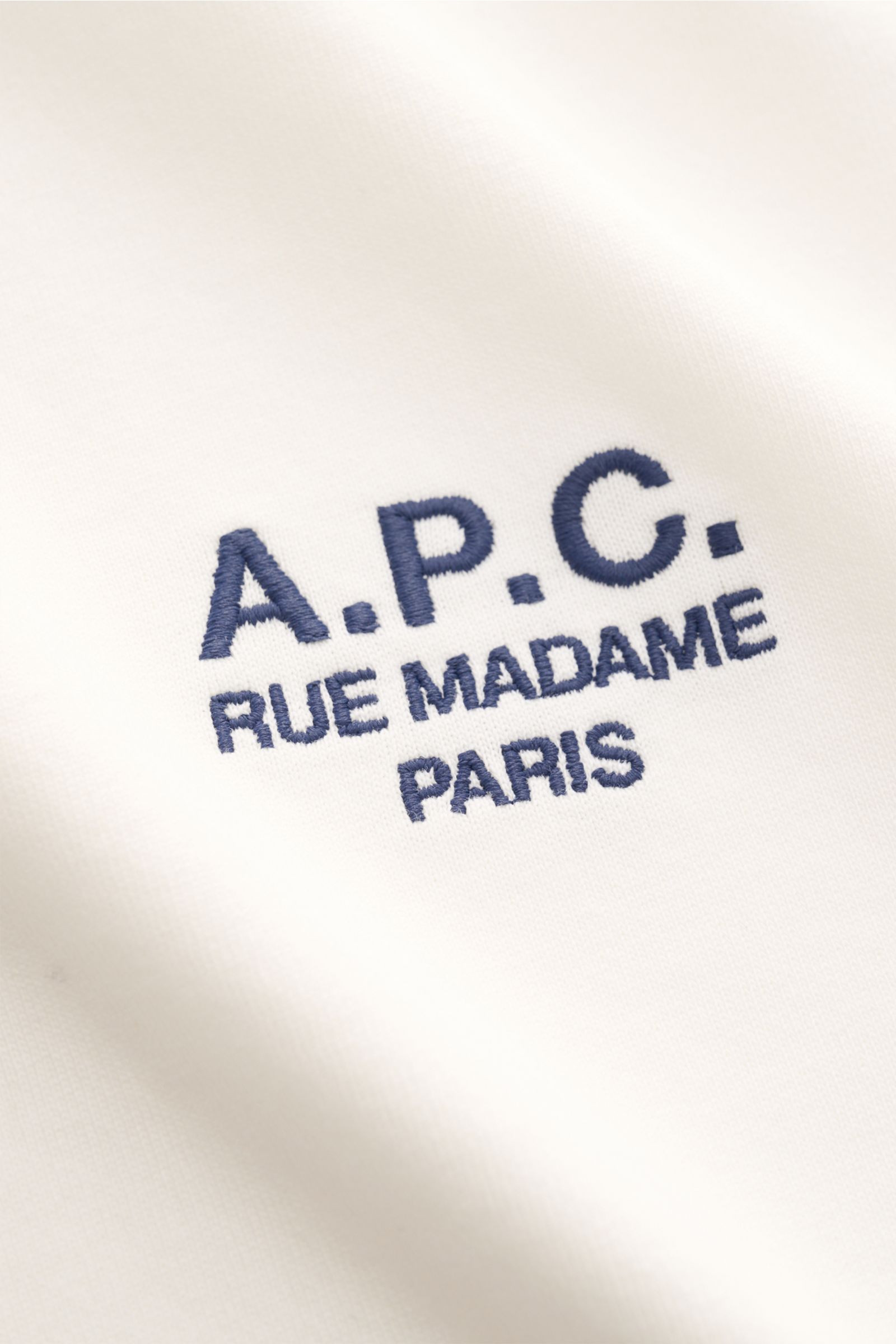Alt tag (125 characters max): Close-up front view of A.P.C. Crew neck T-shirt 'Standard Rue Madame' off-white with navy logo embroidery on chest.

Description to include:  
Clean, cool, A.P.C. – the T-shirt 'Standard Rue Madame' is the epitome of Frenc