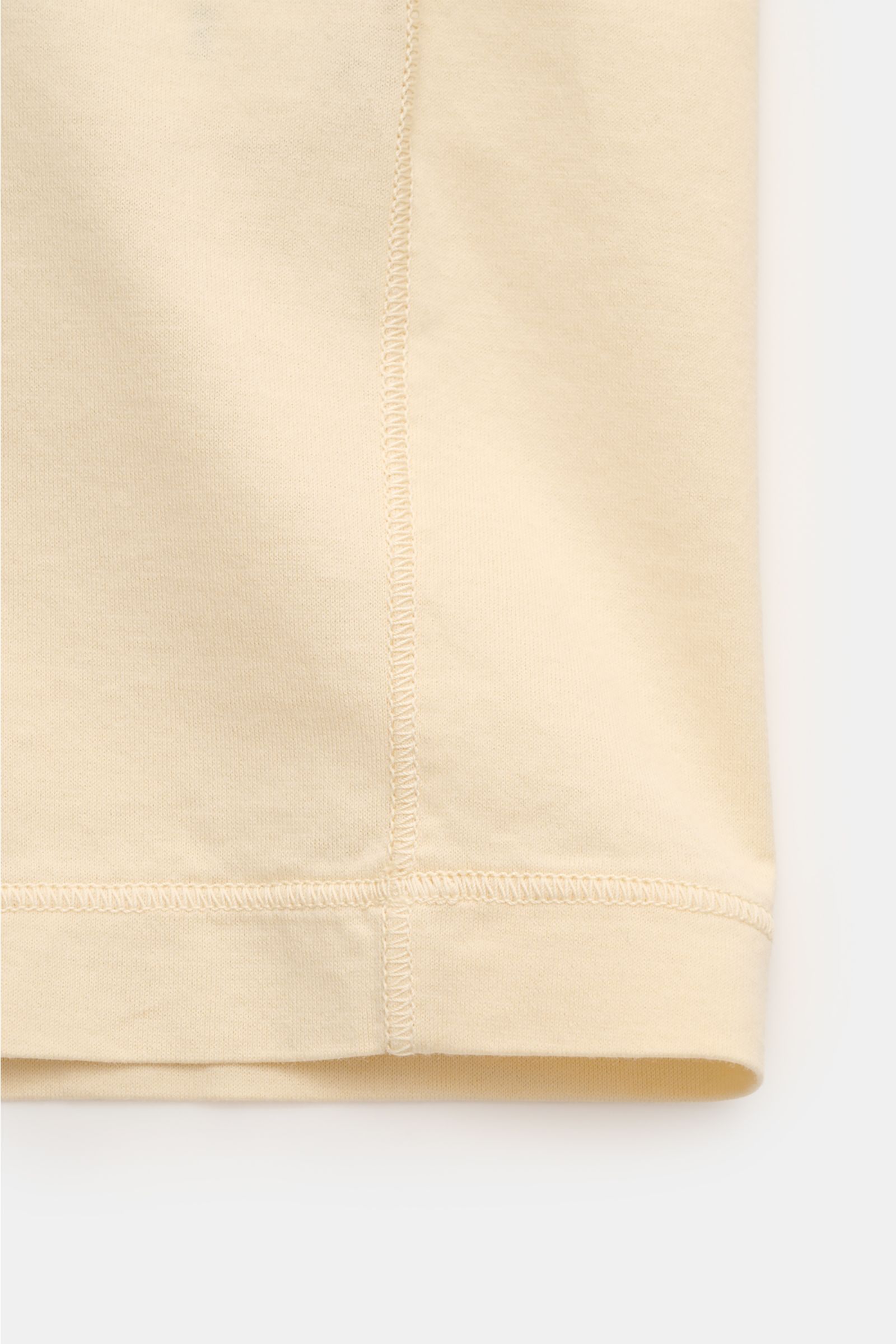 Stone Island Crew neck T-shirt 'Stellina' pastel yellow shown in close-up from the side, highlighting pure cotton jersey, soft feel, slim fit, crew neck, and subtle Stellina stitching. Minimalist expression and precise workmanship: The T-shirt 'Stellina' 