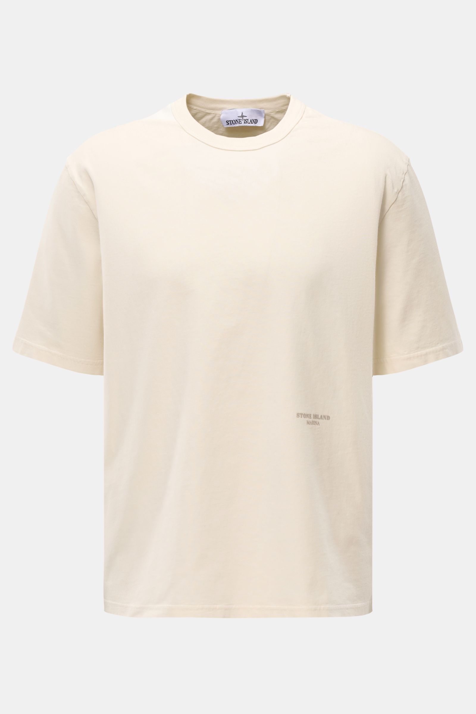 Stone Island Rundhals-T-Shirt 'Marina' creme shown from the front, oversized fit with a soft, heavy cotton fabric, round neckline, contrast ribbed shoulder detail, and subtle logo print on the front. Legeres Urlaubs-Essential: Das T-Shirt aus der STONE