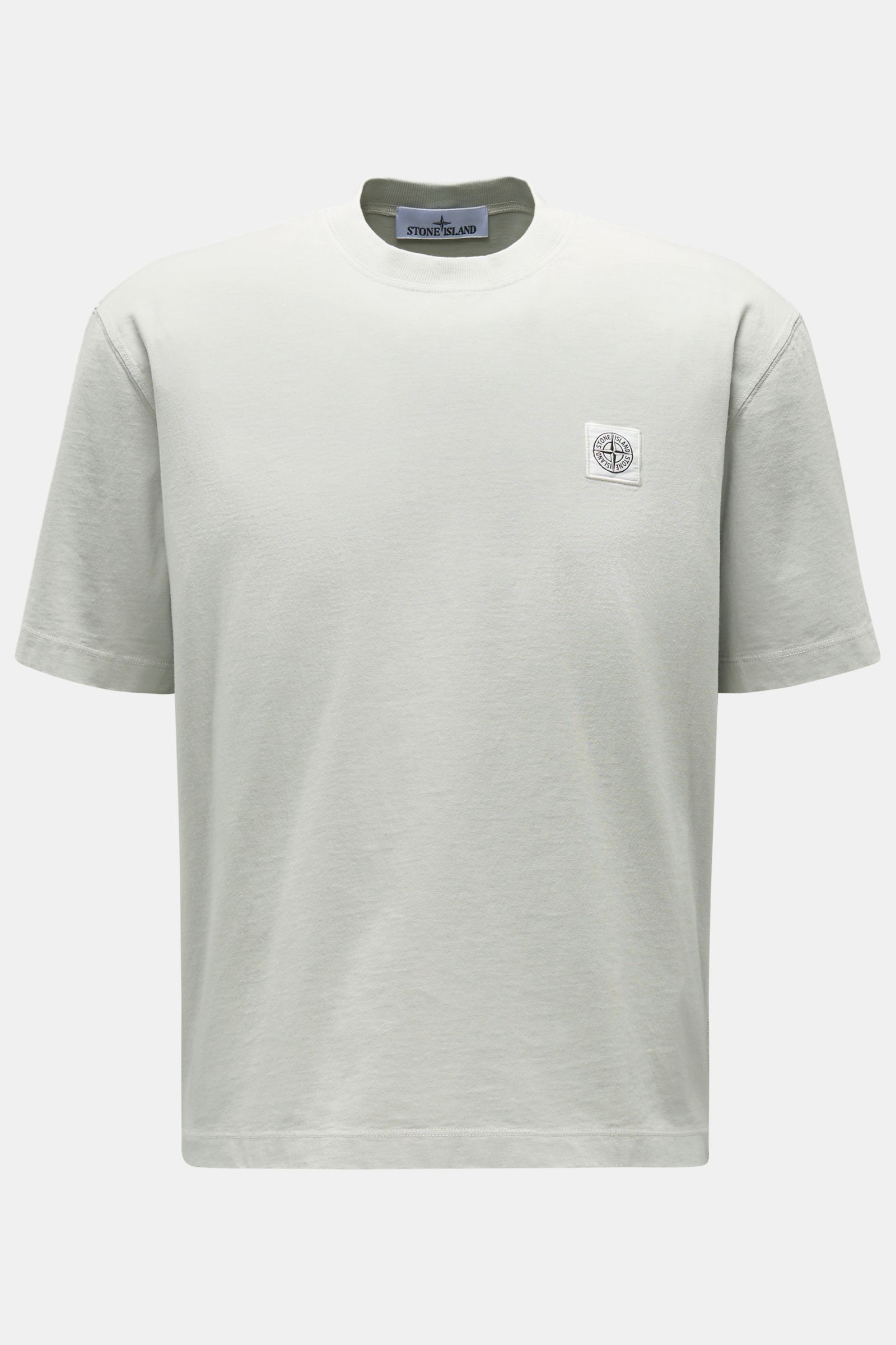 Stone Island Rundhals-T-Shirt hellgrau shown from the front, light gray garment-dyed cotton with compass logo patch on chest.

STONE ISLAND liefert mit diesem legeren T-Shirt aus Garment-dyed-Baumwolle mit charakteristischem Kompass-Logo ein unverzicht