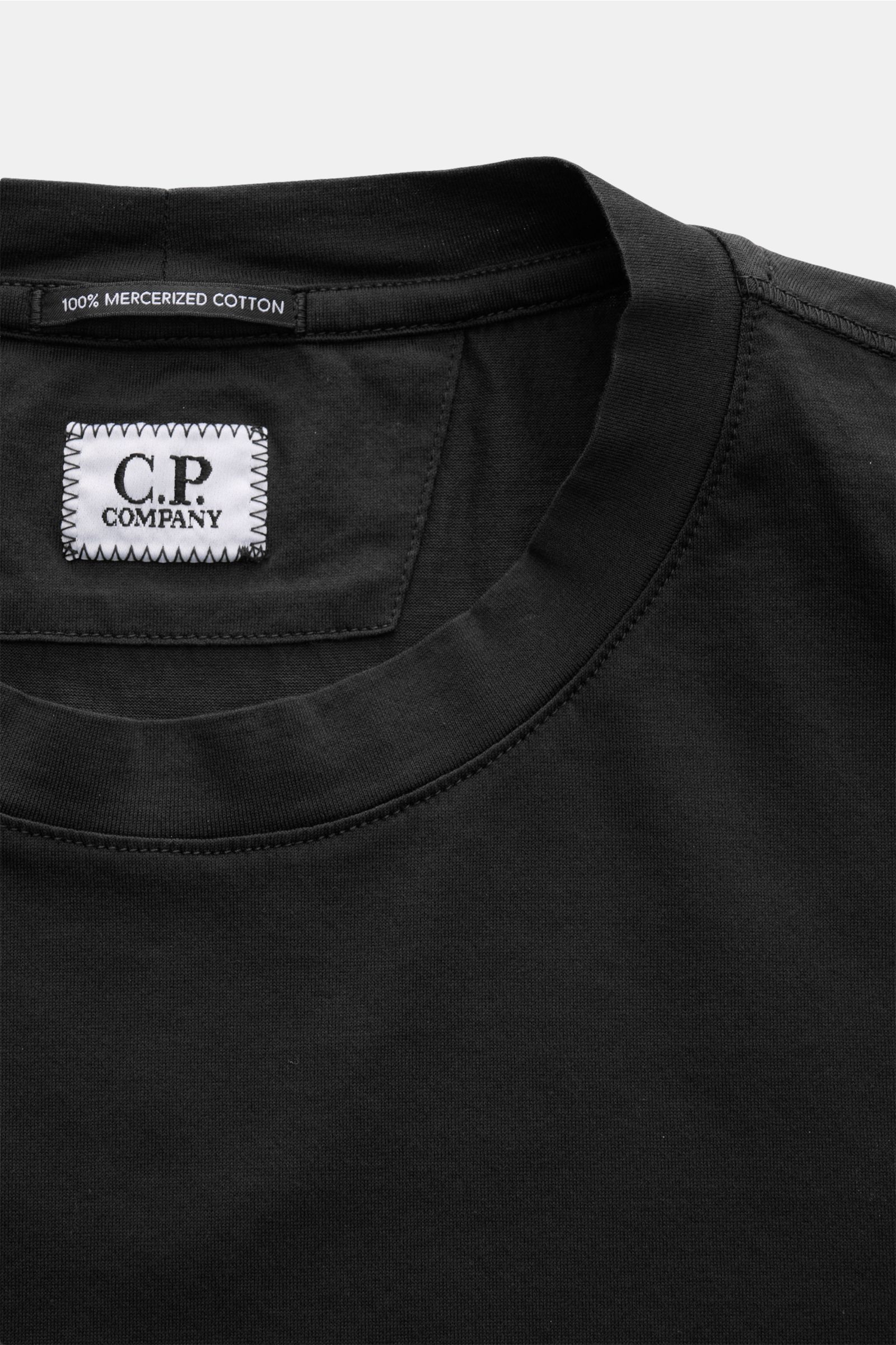 Nahaufnahme des schwarzen C.P. Company Rundhals-T-Shirts aus mercerisierter Baumwolle, Slim Fit mit weichem Griff, Rundhalsausschnitt und Logo-Print auf der Brust, frontal fotografiert.