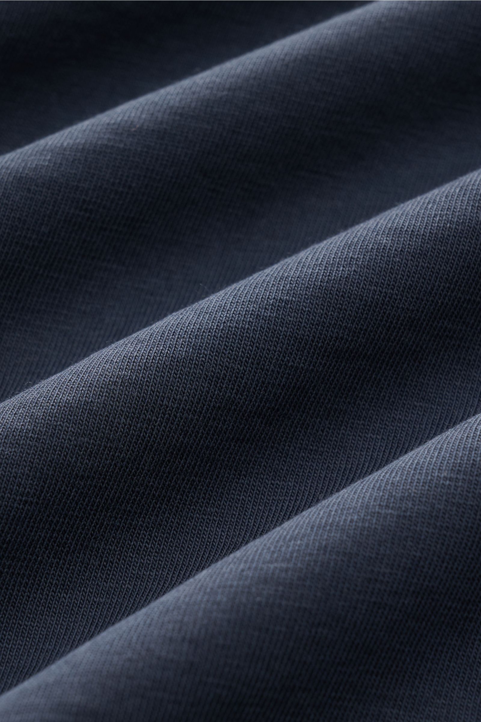 Close-up fabric texture of the B.F. Knitwear Crew neck T-shirt navy, showing pure cotton material with soft feel, photographed from a detailed angled perspective. A high-quality basic for the spring and summer season: This T-shirt by B.F. KNITWEAR is made