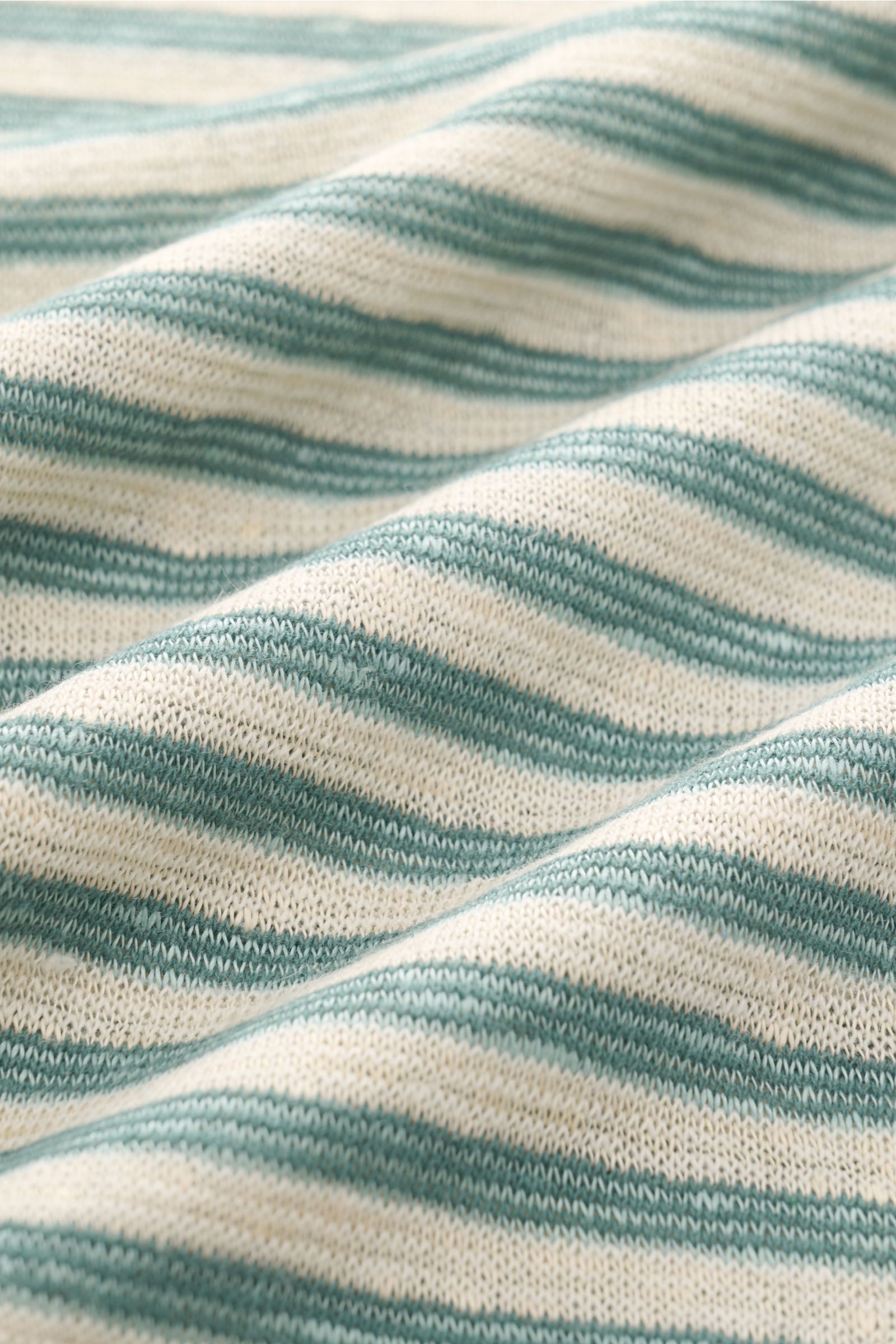 MC2 Saint Barth Crew neck T-shirt 'Dover Stripes' cream/turquoise striped fabric close-up from a front angle, showing soft linen blend texture. For your casual summer looks: The 'Dover Stripes' T-shirt by MC2 SAINT BARTH, made from a soft linen blend, add