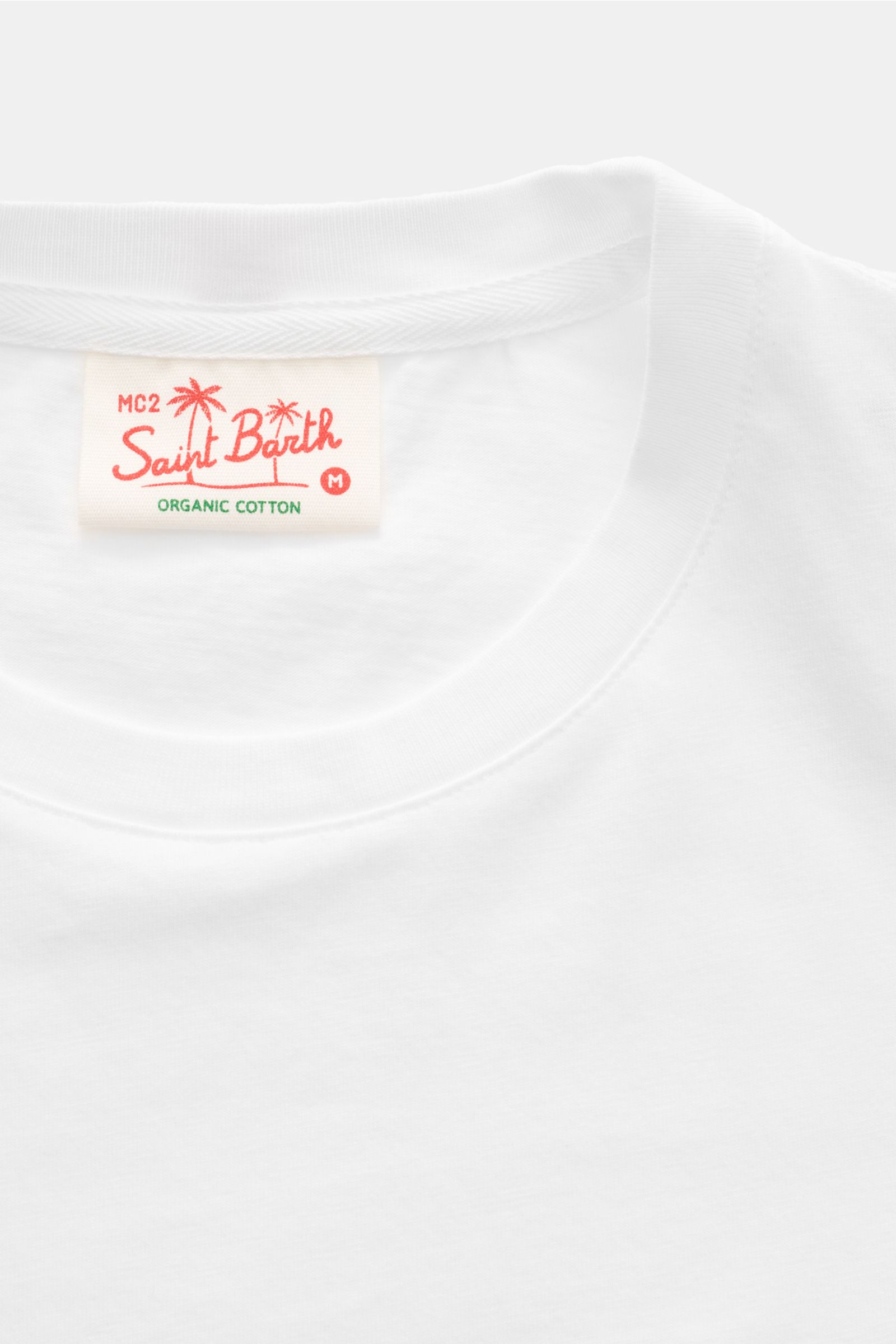 Close-up front view of the MC2 Saint Barth 'Portofino' crew neck T-shirt white, showing soft organic cotton fabric and label.

Summery and eye-catching: This T-shirt by MC2 SAINT BARTH, made from soft organic cotton, features eye-catching stitching on 