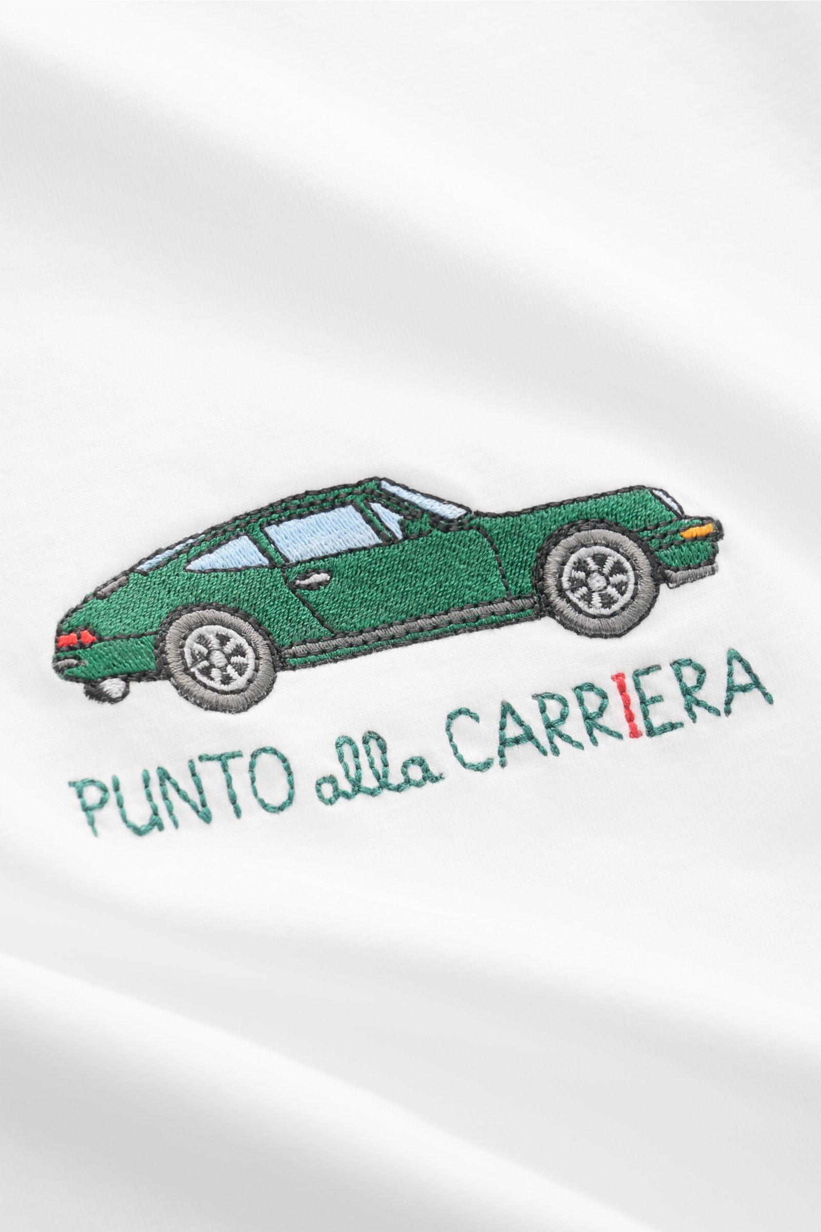 Close-up front view of the MC2 Saint Barth 'Portofino' crew neck T-shirt white showing green car stitching and 'PUNTO alla CARRIERA' embroidery on soft organic cotton fabric.

Summery and eye-catching: This T-shirt by MC2 SAINT BARTH, made from soft or