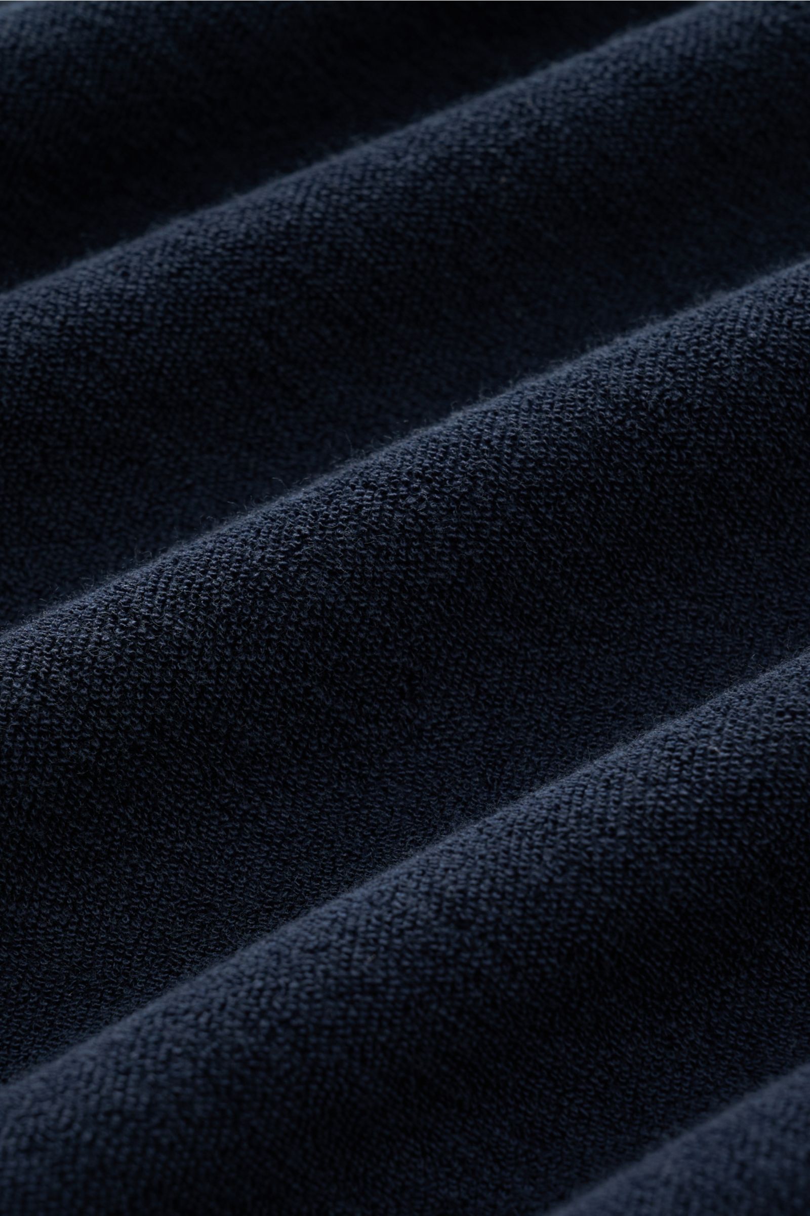 Close-up angled view of the navy terrycloth fabric of the 04651/ A trip in a bag Terry T-shirt 'Terry Tee' navy, showing soft texture. 

The clean T-shirt 'Terry Tee' by 04651/ A TRIP IN A BAG is made of soft terry in pure cotton fabric and is the perf