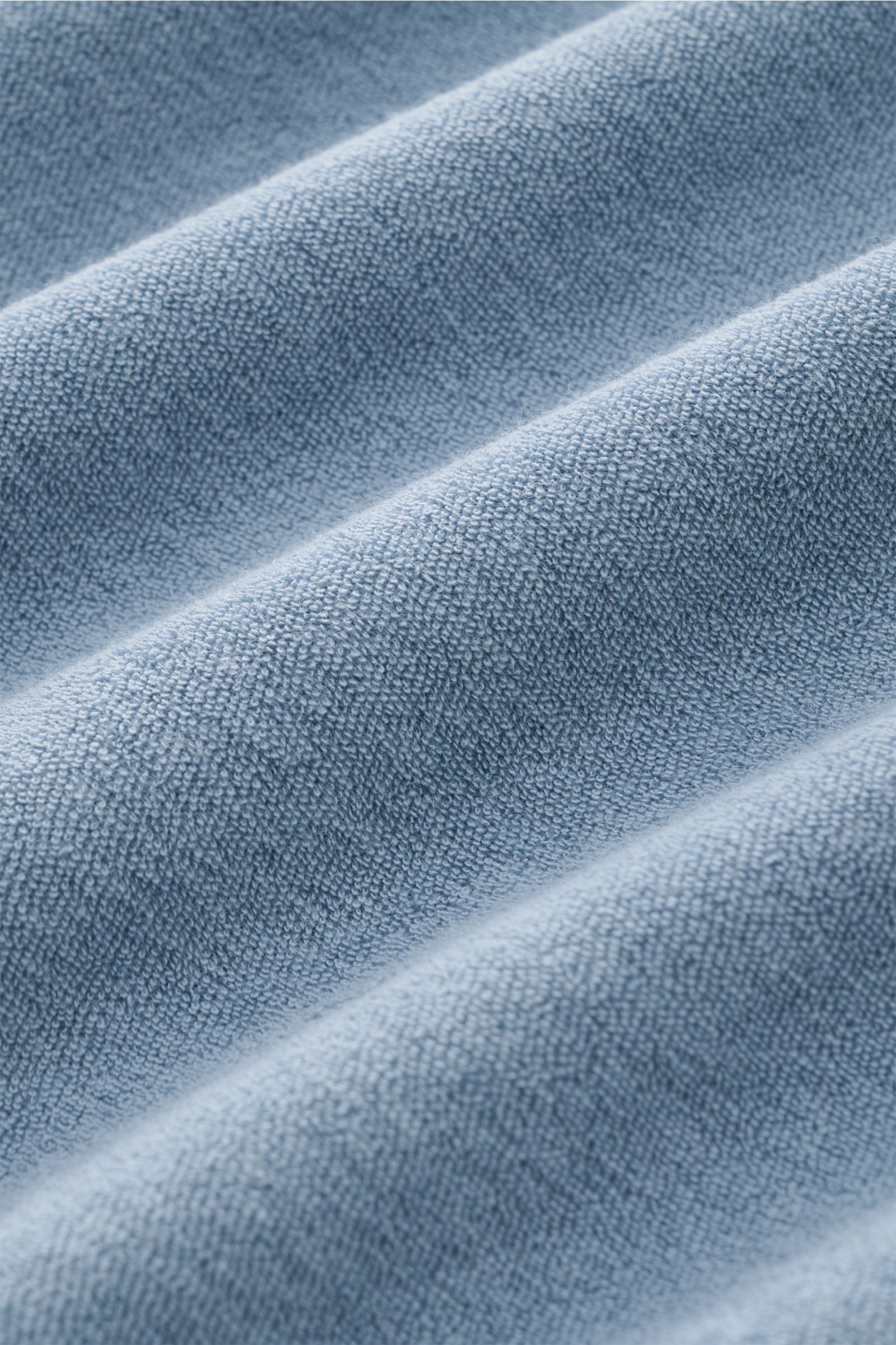 Close-up fabric texture of the 04651/ A trip in a bag Terry T-shirt 'Terry Tee' smoky blue showing soft pure cotton terrycloth material.

The clean T-shirt 'Terry Tee' by 04651/ A TRIP IN A BAG is made of soft terry in pure cotton fabric and is the per