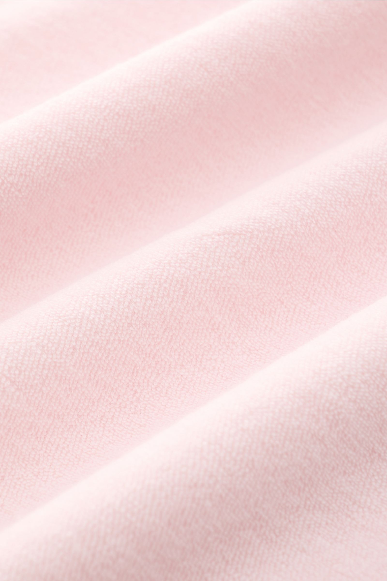 Close-up view of soft pink terrycloth fabric texture of the 04651/ A trip in a bag Terry T-shirt 'Terry Tee' rose, showing fine cotton loops.

The clean T-shirt 'Terry Tee' by 04651/ A TRIP IN A BAG is made of soft terry in pure cotton fabric and is th