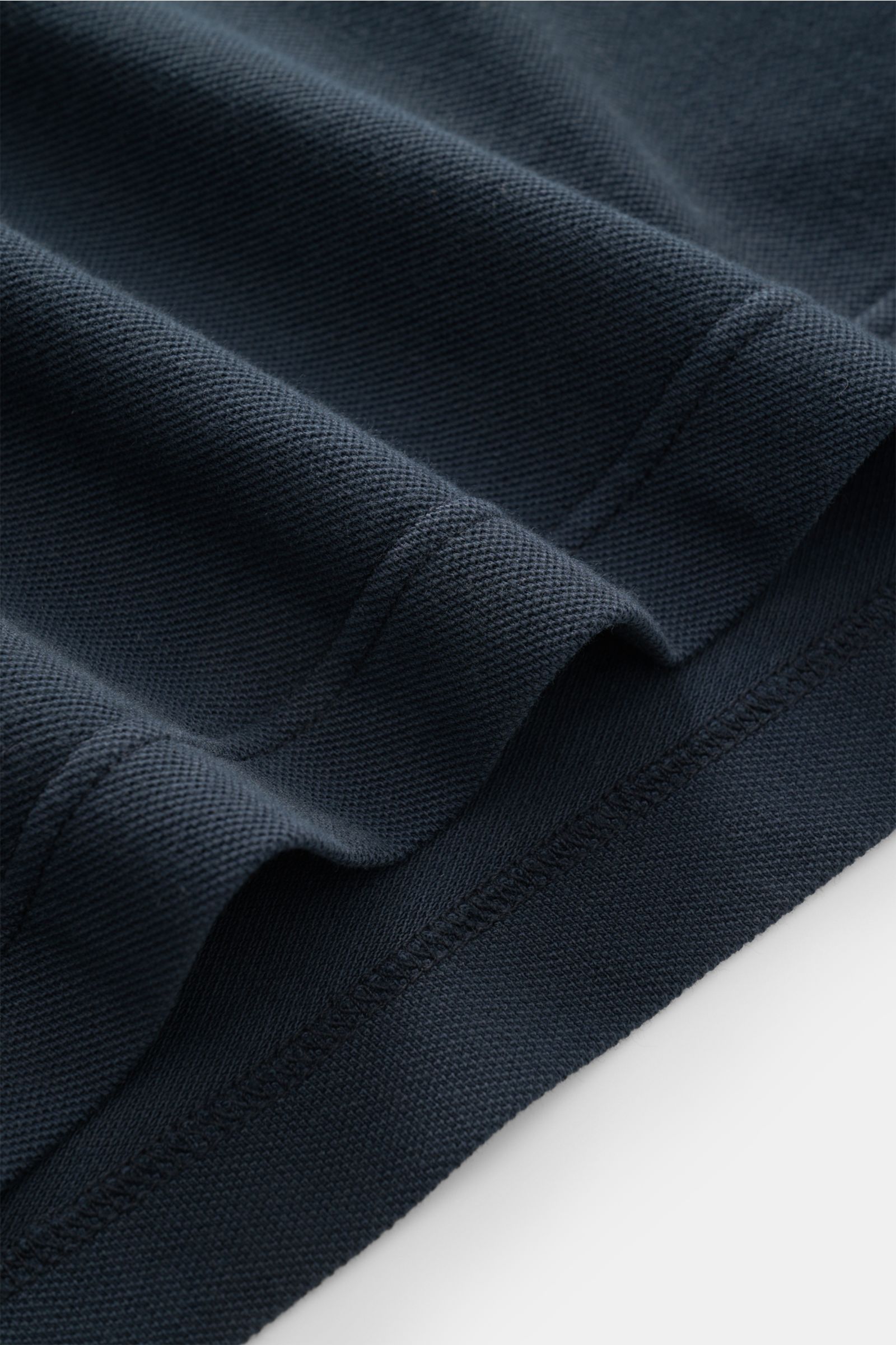 Close-up view of navy piqué fabric texture and stitching on the sleeve hem of the 04651/ A trip in a bag Piqué T-shirt navy.

Summer essential: This piqué T-shirt from 04651/ A TRIP IN A BAG is a versatile staple that's perfect for warm days.

