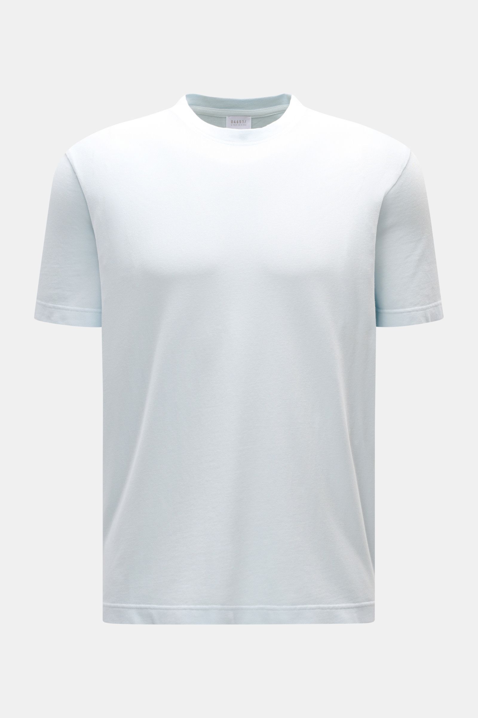 Front view of the 04651/ A trip in a bag Piqué T-shirt pastel blue, made of pure piqué cotton with a slim fit, crew neck, ribbed bands, and woven label in the side seam, offering a robust feel perfect for warm days.