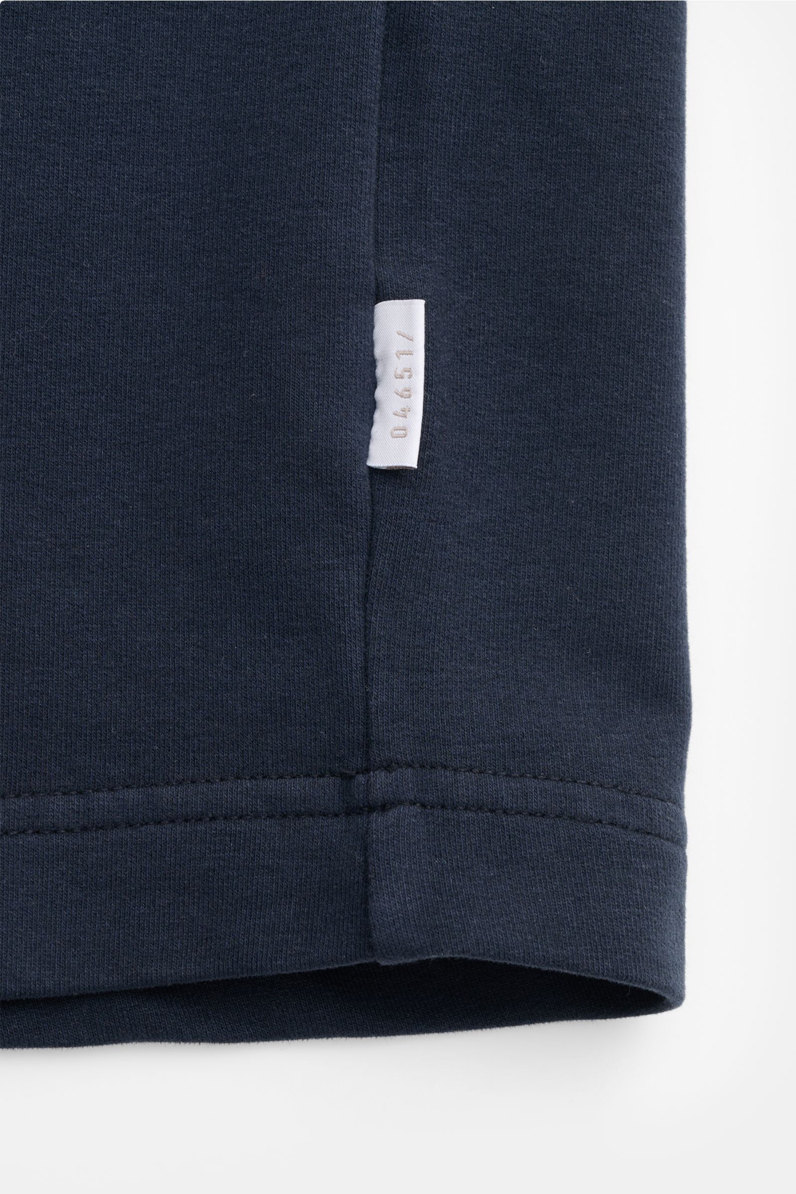Close-up side seam view of the navy 04651/ A trip in a bag Crew neck T-shirt 'If Tee' showing woven label and fabric texture.

The uncomplicated cotton T-shirt 'IF Tee' by 04651/ A TRIP IN A BAG is a core basic for the new season that gives a taste of 