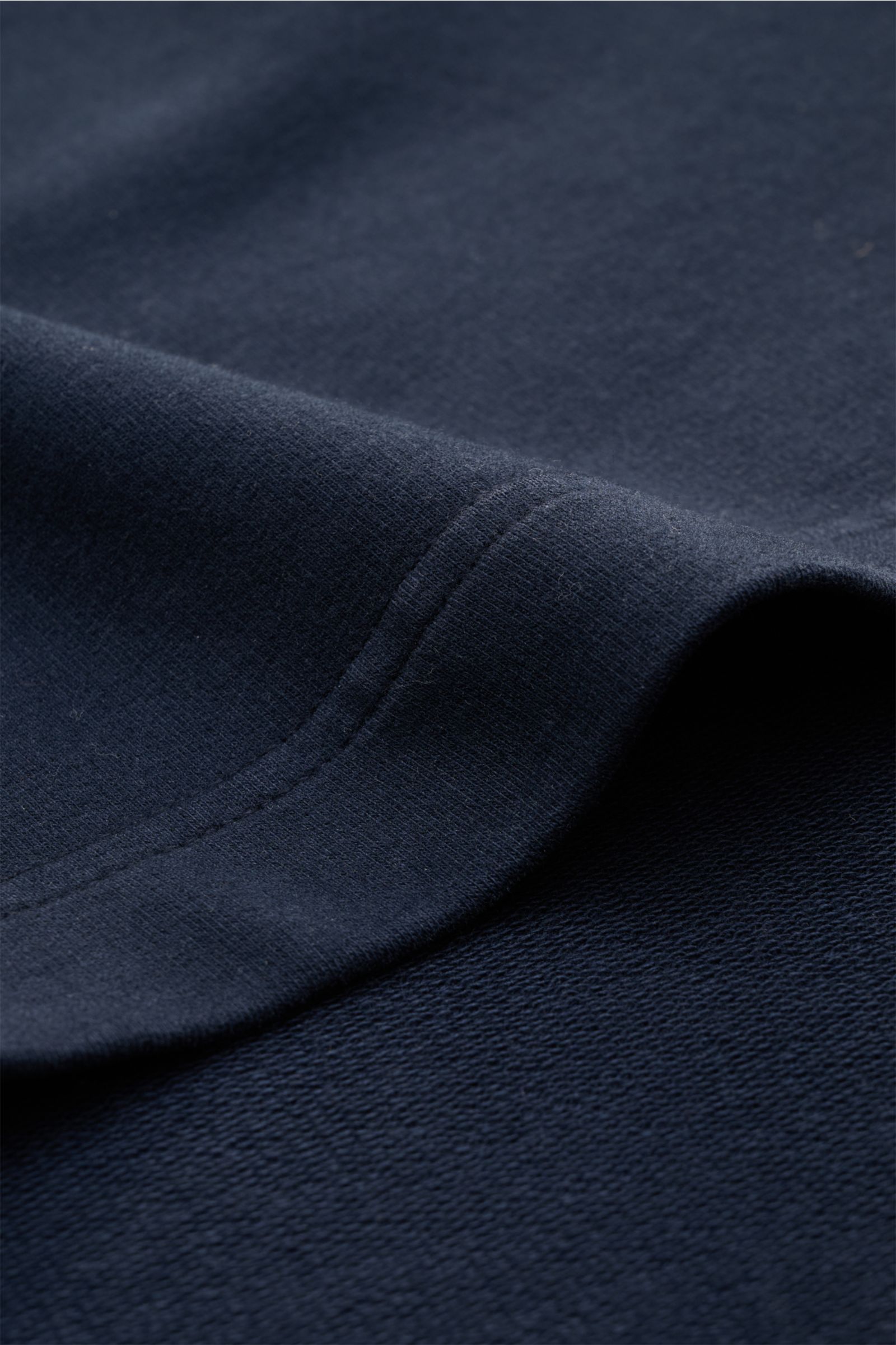 Close-up, angled view of navy jersey fabric and stitching of the 04651/ A trip in a bag Crew neck T-shirt 'If Tee' navy, showing soft, heavy cotton texture.

The uncomplicated cotton T-shirt 'IF Tee' by 04651/ A TRIP IN A BAG is a core basic for the ne