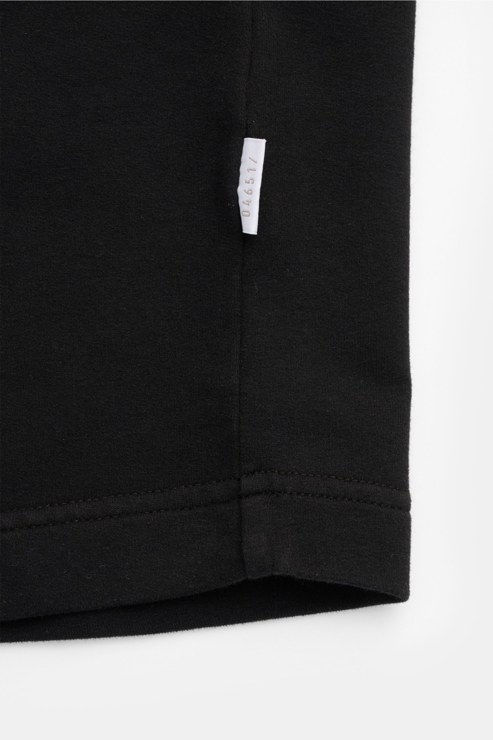 Close-up side seam view of the black 04651/ A trip in a bag Crew neck T-shirt 'If Tee' showing the white woven label.

The uncomplicated cotton T-shirt 'IF Tee' by 04651/ A TRIP IN A BAG is a core basic for the new season that give us a taste of a rela