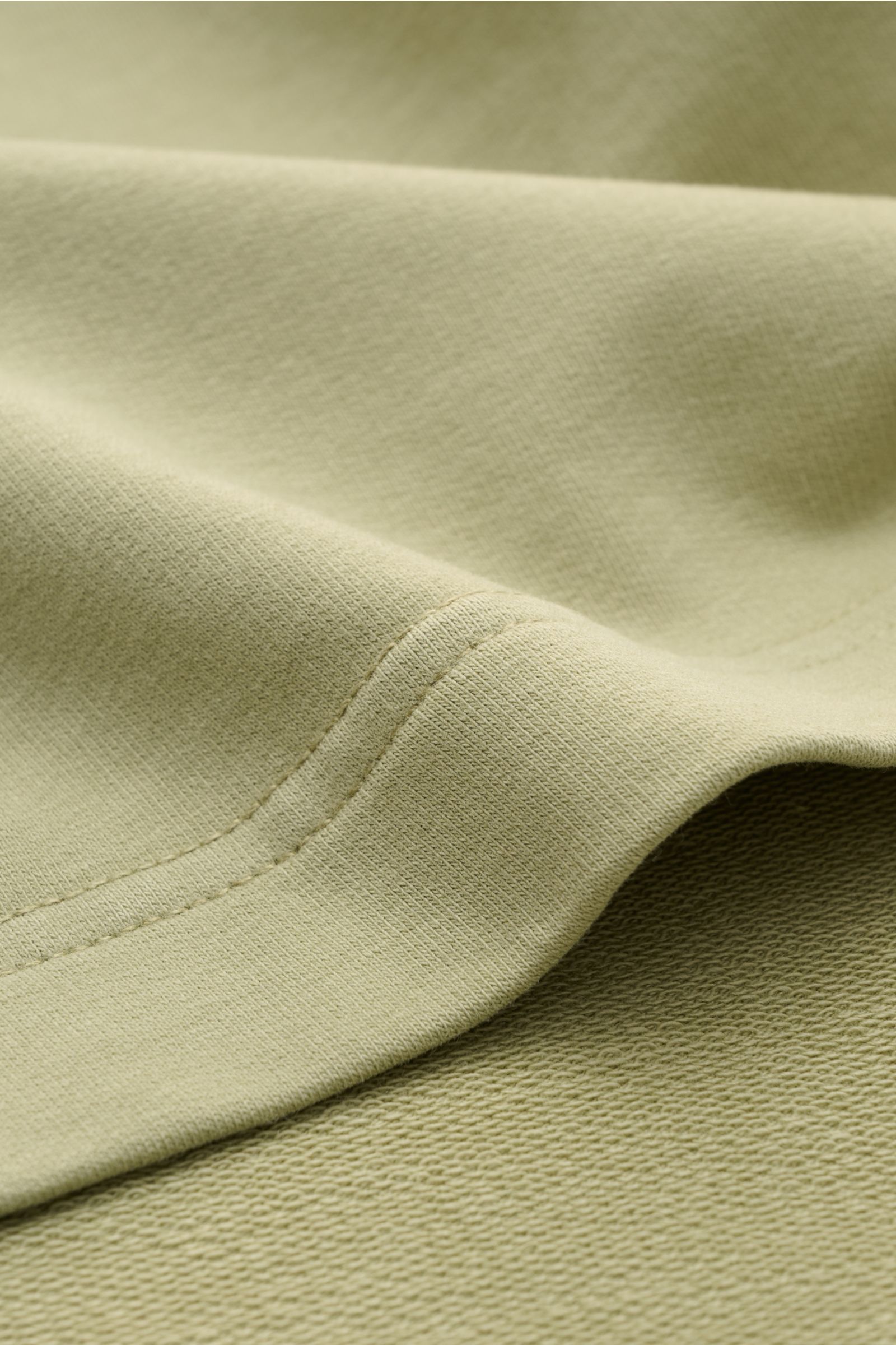 Close-up fabric detail of 04651/ A trip in a bag Crew neck T-shirt 'If Tee' sage showing elasticated cotton jersey from a top-down perspective.

The uncomplicated cotton T-shirt 'IF Tee' by 04651/ A TRIP IN A BAG is a core basic for the new season that