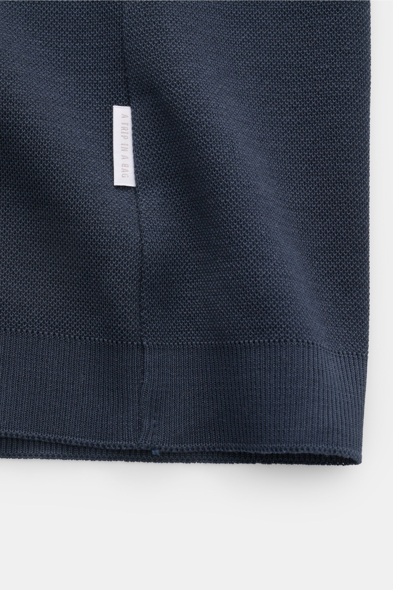 Nahaufnahme des Saums und Weblabels des 04651/ A trip in a bag Piqué-T-Shirt 'TP' navy aus reiner Baumwolle mit Slim Fit und Rippbündchen.