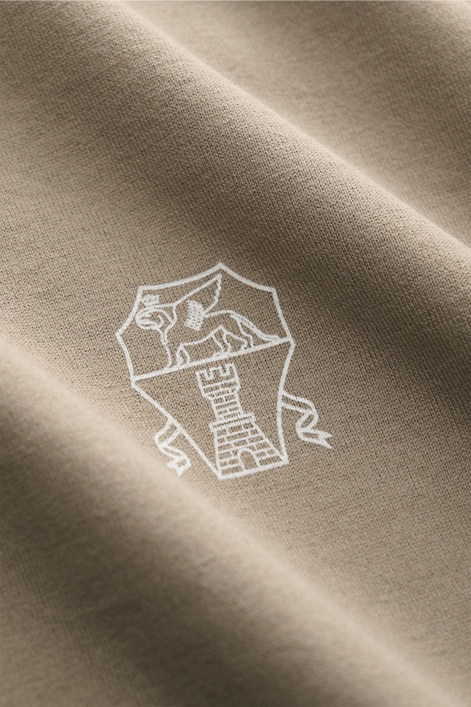 Close-up front view of the taupe Brunello Cucinelli Rundhals-T-Shirt showing fine cotton jersey fabric and white logo print.

Description: Luxuriöse Materialqualität und feinste Verarbeitung verleihen dem Rundhals-T-Shirt aus reinem Baumwolljersey von 