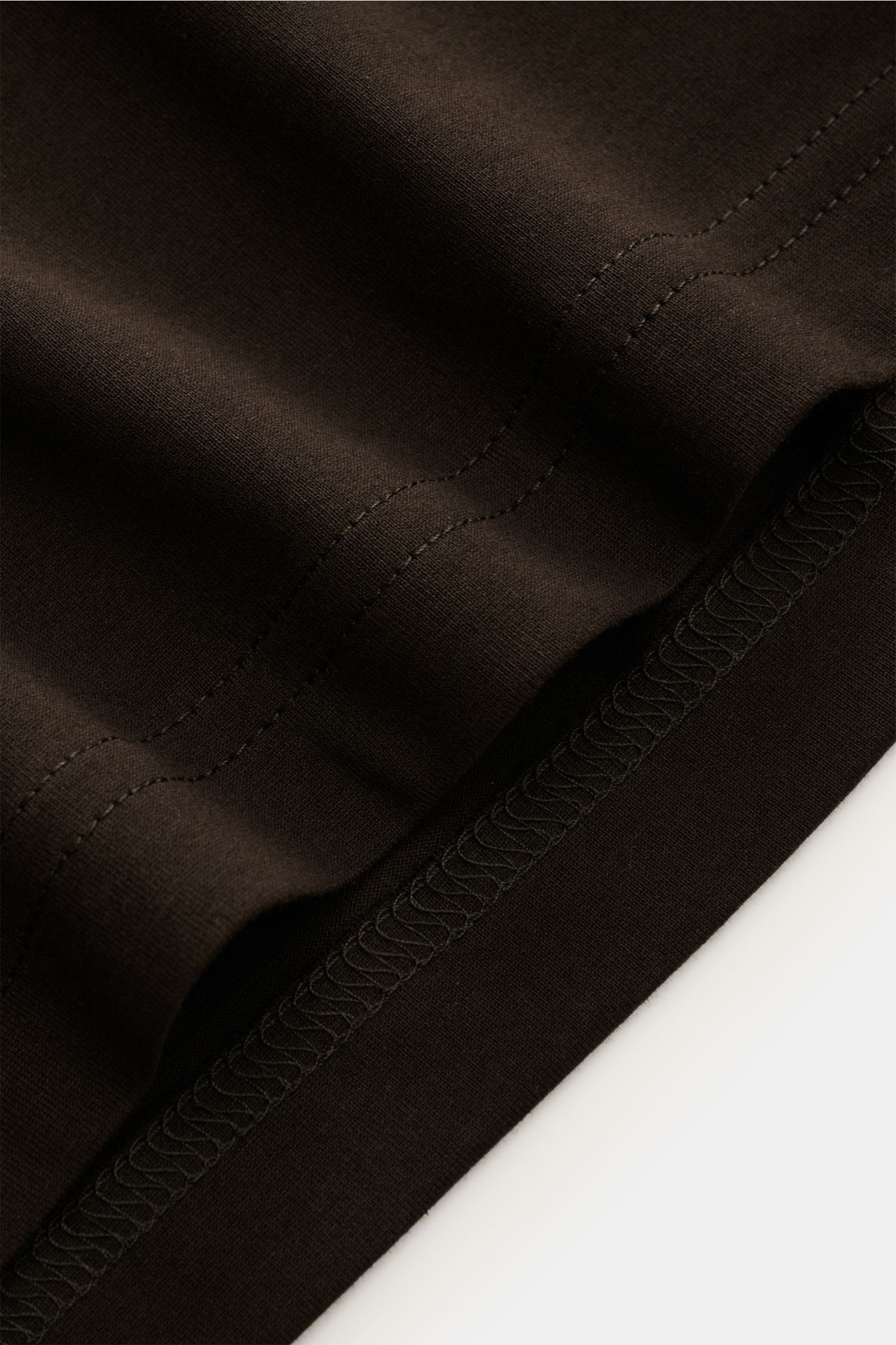 Close-up angled view of the Stefan Brandt Crew neck long sleeve 'Enno' dark brown showing fine jersey fabric, pure Pima cotton, soft smooth feel, slim fit, and crew neck stitching details.