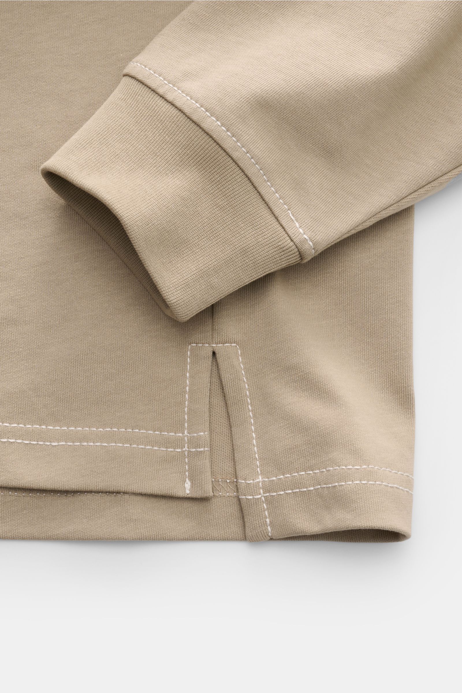 Close-up front view of Ami Paris Long sleeve taupe showing cuff, hem with quilted seams, and fabric texture in taupe color.

Create perfect urban looks with this long sleeve by AMI PARIS – the quilted seams and signature heart logo on the hem make it a