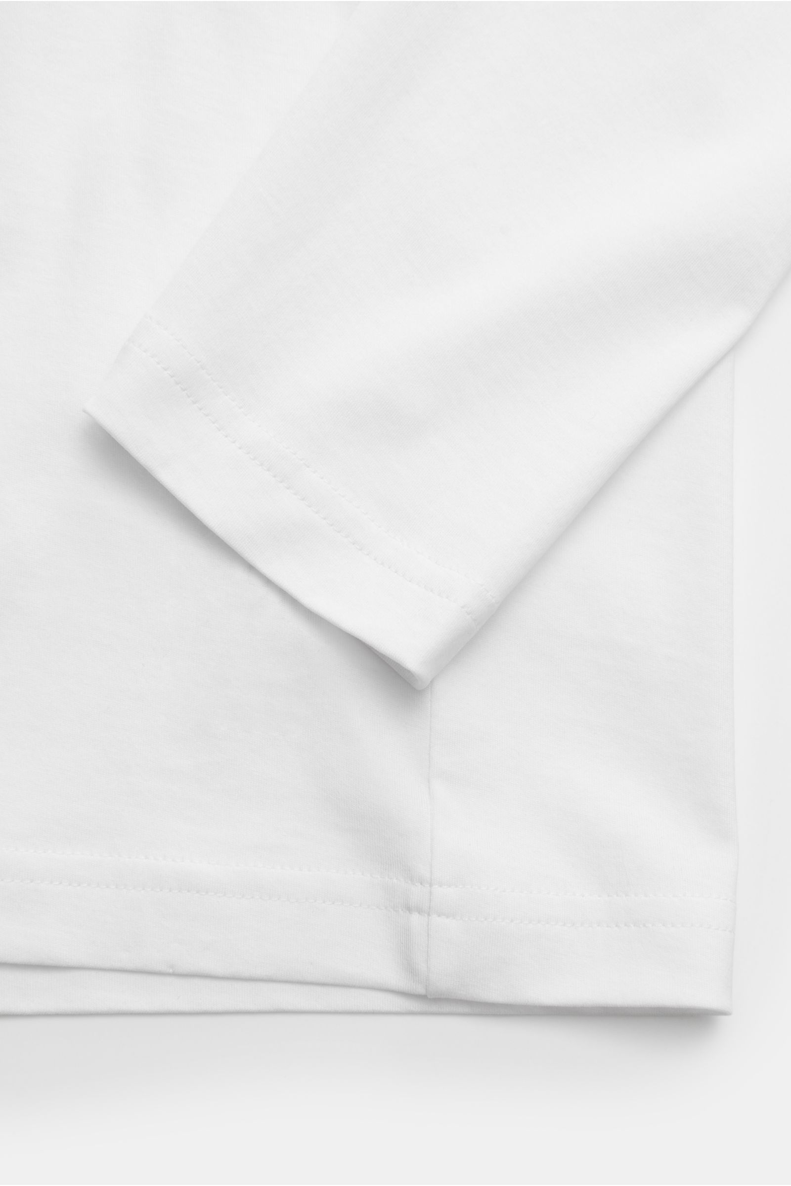 Nahaufnahme des weißen Stefan Brandt Rundhals-Longsleeve 'Eli' aus biologischer Pima-Baumwolle, Slim Fit, feine Jersey-Qualität mit Rundhalsausschnitt, fotografiert von oben.