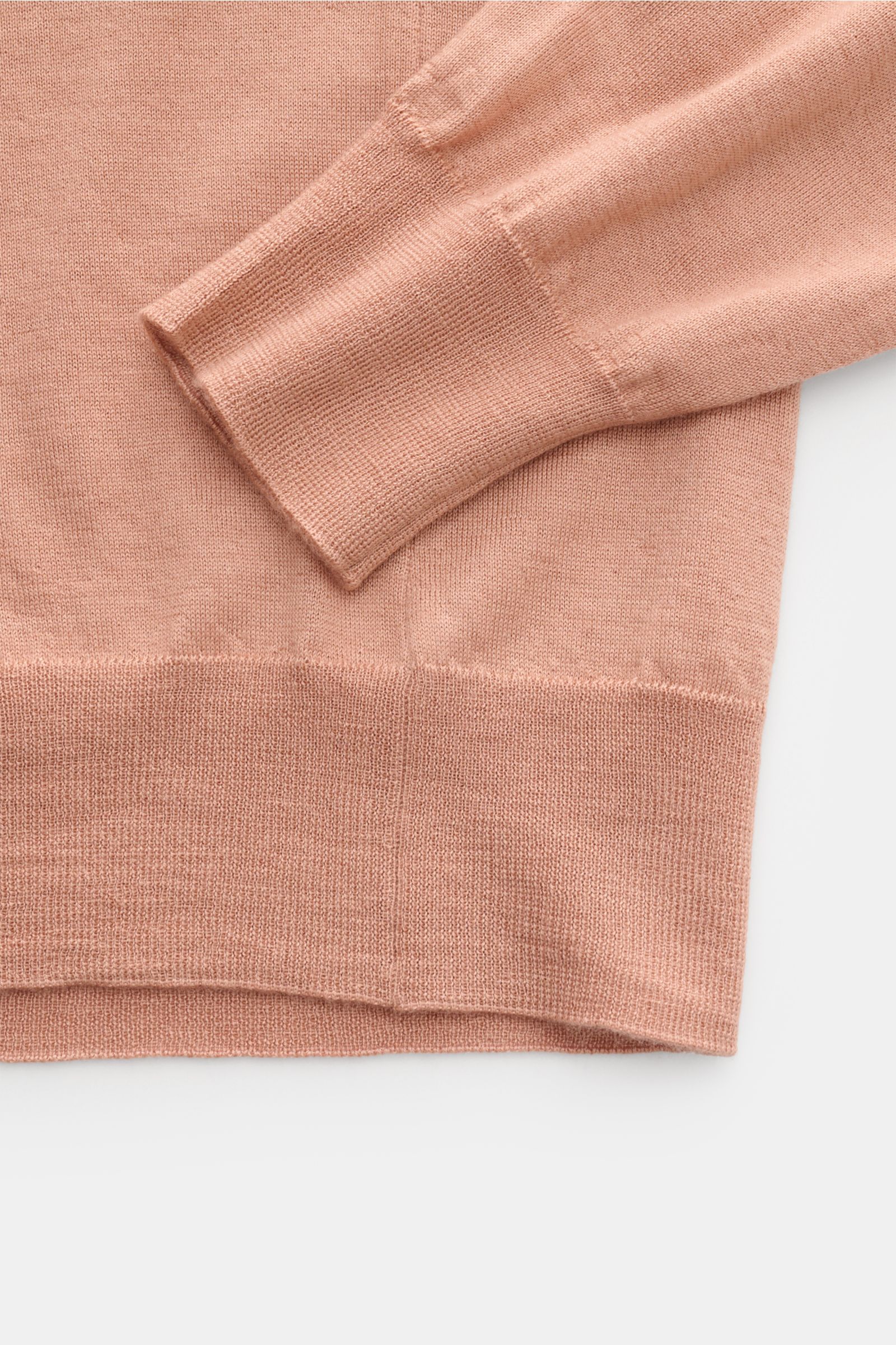 Filippo de Laurentiis Crew neck jumper apricot shown from a close-up side angle focusing on the sleeve cuff and hem, made from a fine silk-cashmere blend with a very soft feel, slim fit, comfortable ribbed bands, and fine knit.