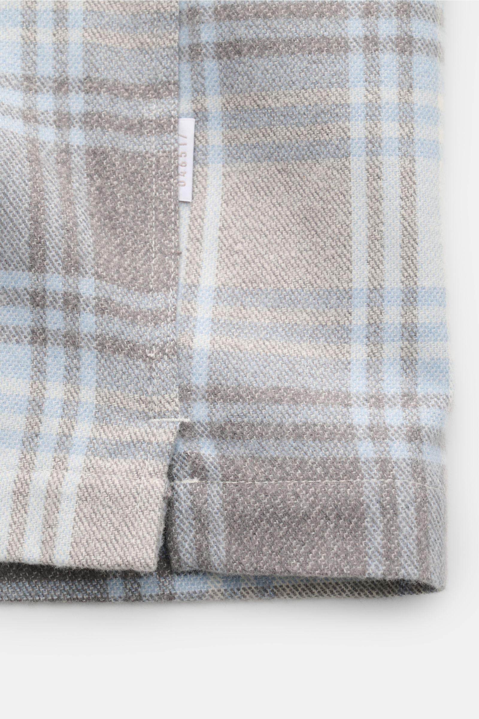 Close-up side view of 04651/ A trip in a bag Overshirt 'Check Overshirt' off-white/light blue/grey checked in flannel look, pure cotton, soft feel, modern checked pattern, regular fit, six-button placket, turn-down collar, patch breast pockets, cuffs with