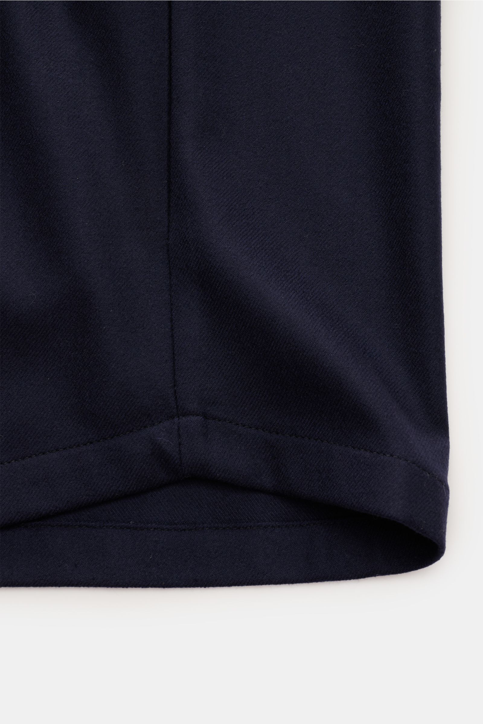 Close-up view of the lower front hem of the Colombo Overshirt navy, made from finest wool with microfibre, featuring slightly elasticated fabric and a very soft feel. The slim fit overshirt includes a six-button placket, turn-down collar, concealed pocket