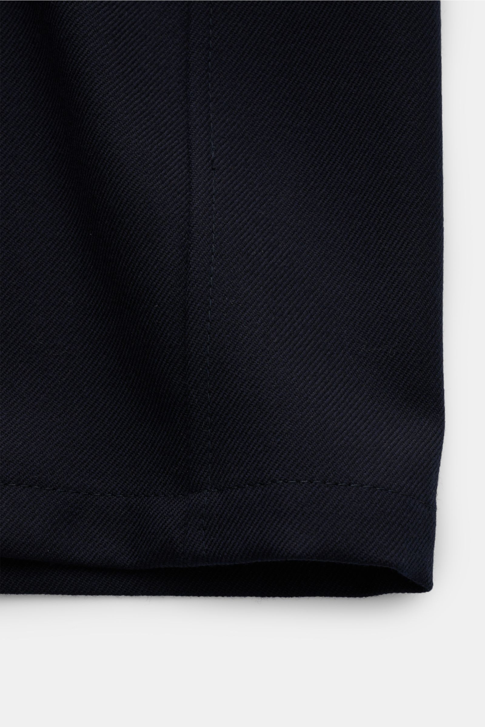 Close-up front view of the hem of the Incotex Overshirt navy, made from a mix of virgin wool and cashmere with a slight stretch, showcasing the textured, grippy fabric and slim fit design.

Wenn die Grenzen zwischen Hemd und Jacke verschwimmen, entsteh