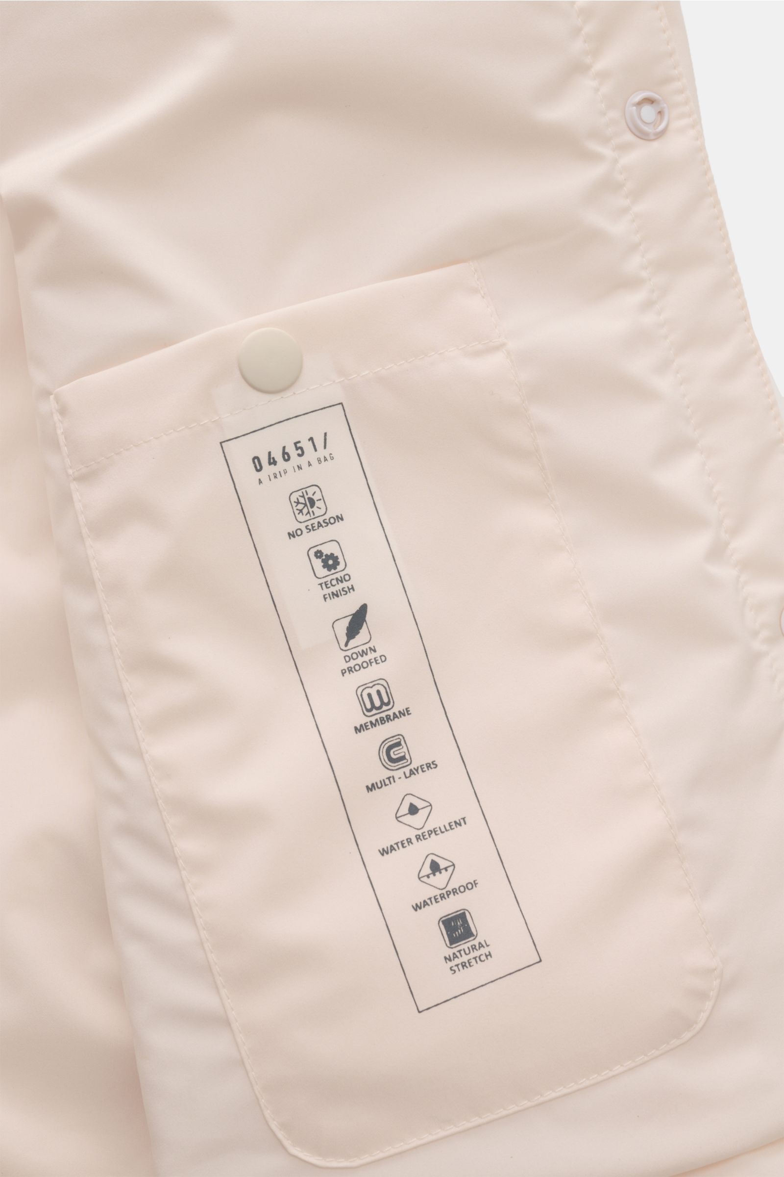 Close-up inside view of the creme 04651/ A trip in a bag Overshirt 'Travel', showing the inner pocket with printed product features and a snap button.

Description including provided content: This image shows a close-up from the inside perspective of the 