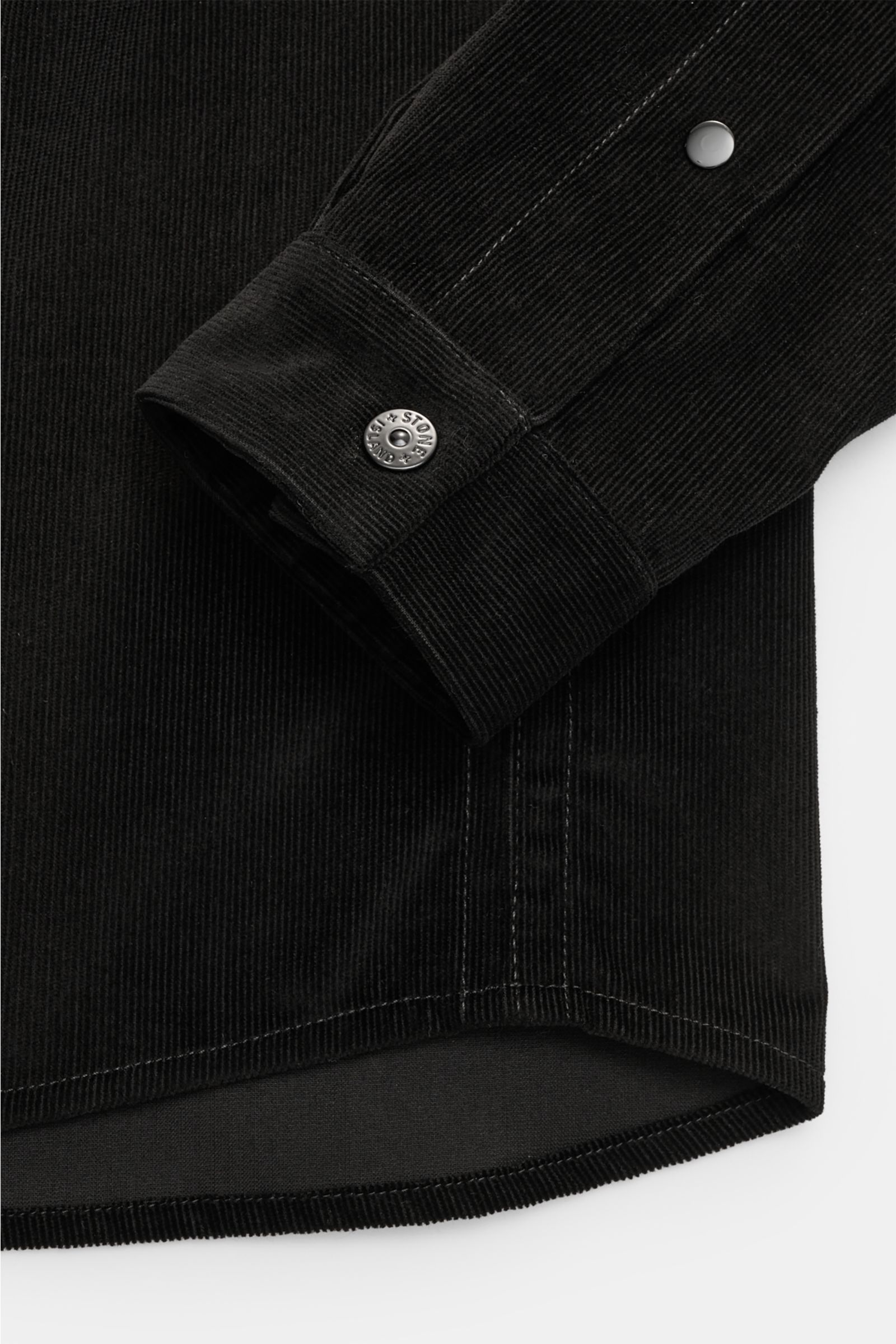 Close-up view of the sleeve cuff and hem of the Stone Island Corduroy overshirt black, showing snap button and corduroy texture.

Description: Sporty and practical – this straight cut overshirt by STONE ISLAND is characterised by iconic style and pure 