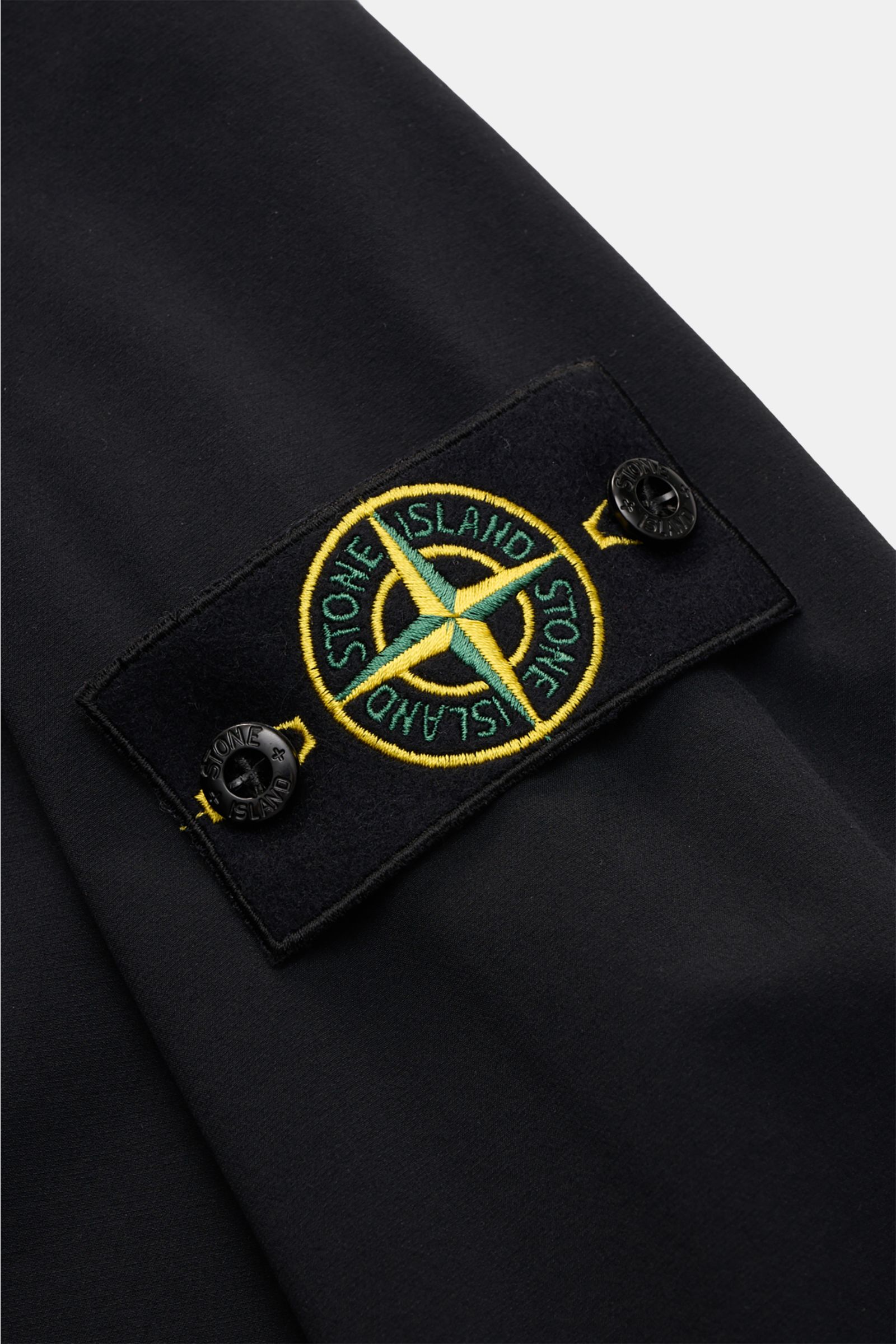 Close-up of the sleeve with the compass badge on the Stone Island Overshirt 'Nylon Stretch' black, showing stretchy microfibre fabric.
