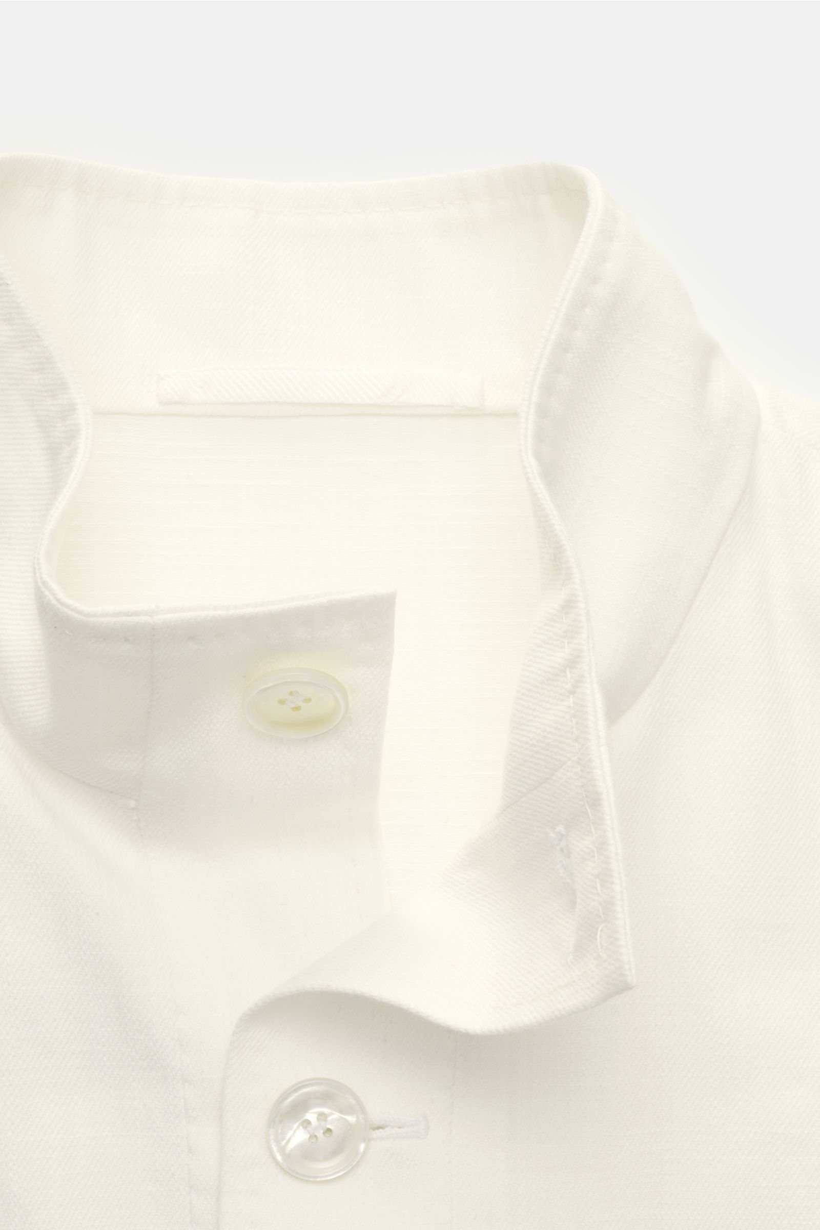 Close-up front view of the Stile Latino Overshirt 'Gbu Teseo' cream showing the standing collar, seven-button placket, and smooth cotton fabric. Luxurious layers: This sophisticated overshirt by STILE LATINO combines exquisite quality with timeless elegan