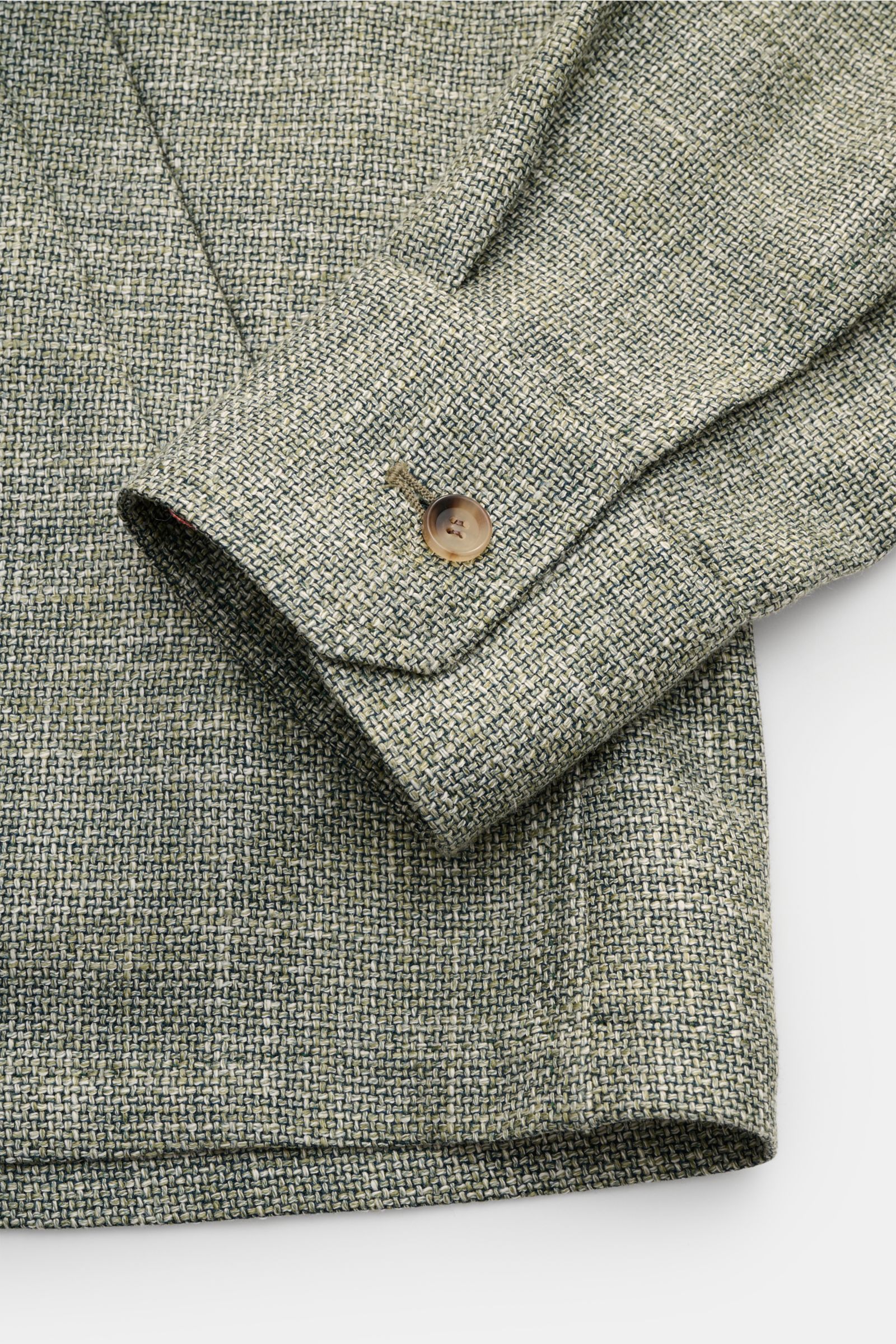 Close-up front-side view of the Stile Latino Overshirt 'Gu Texas' dark green/off-white mottled showing buttoned cuff and woven fabric texture. Luxurious layers: This sophisticated overshirt by STILE LATINO combines exquisite quality with timeless elegance