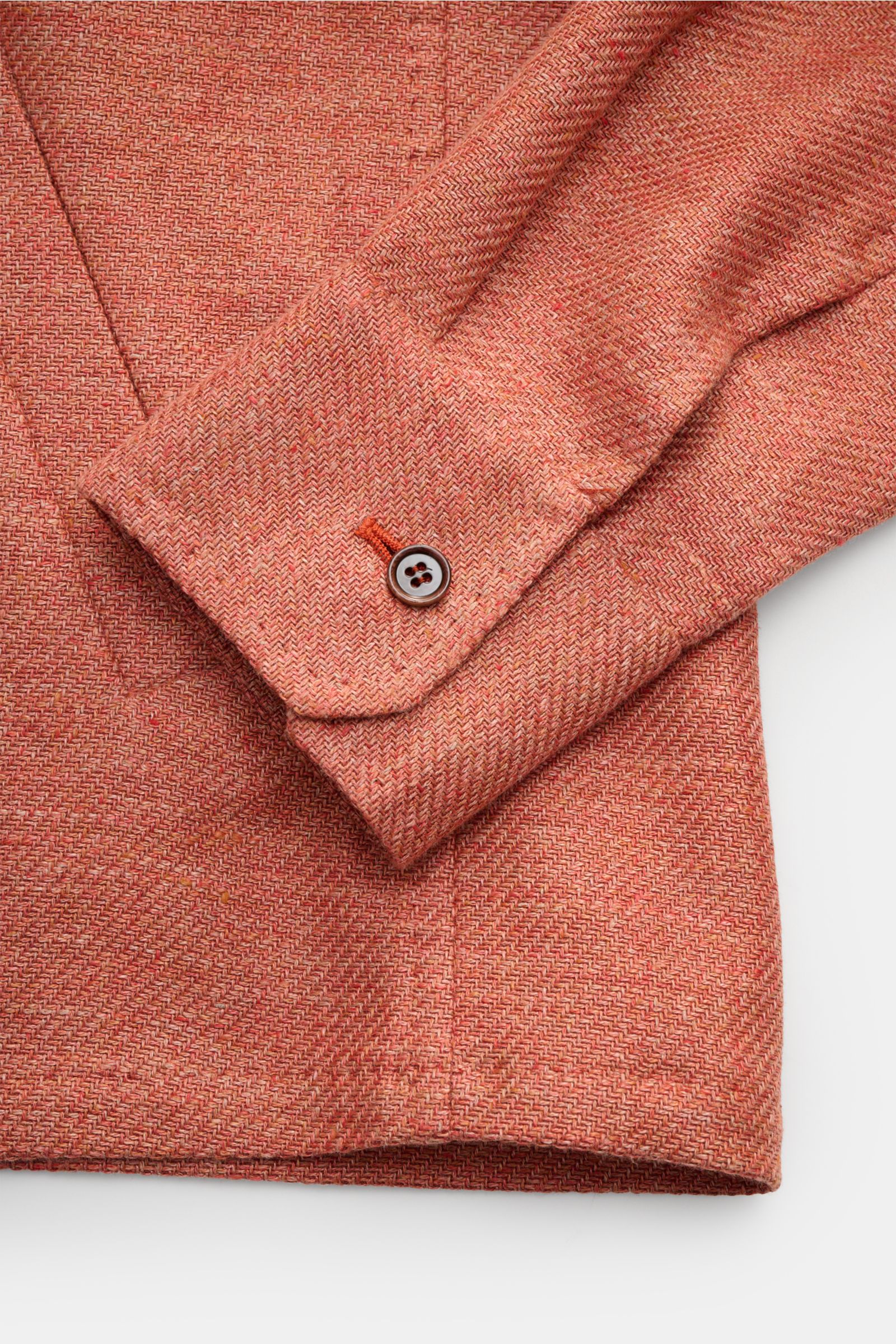 Close-up angled view of the Stile Latino Overshirt 'Gu Texas' orange mottled sleeve and cuff showing linen-cotton blend texture and button detail. Luxurious layers: This sophisticated overshirt by STILE LATINO combines exquisite quality with timeless eleg