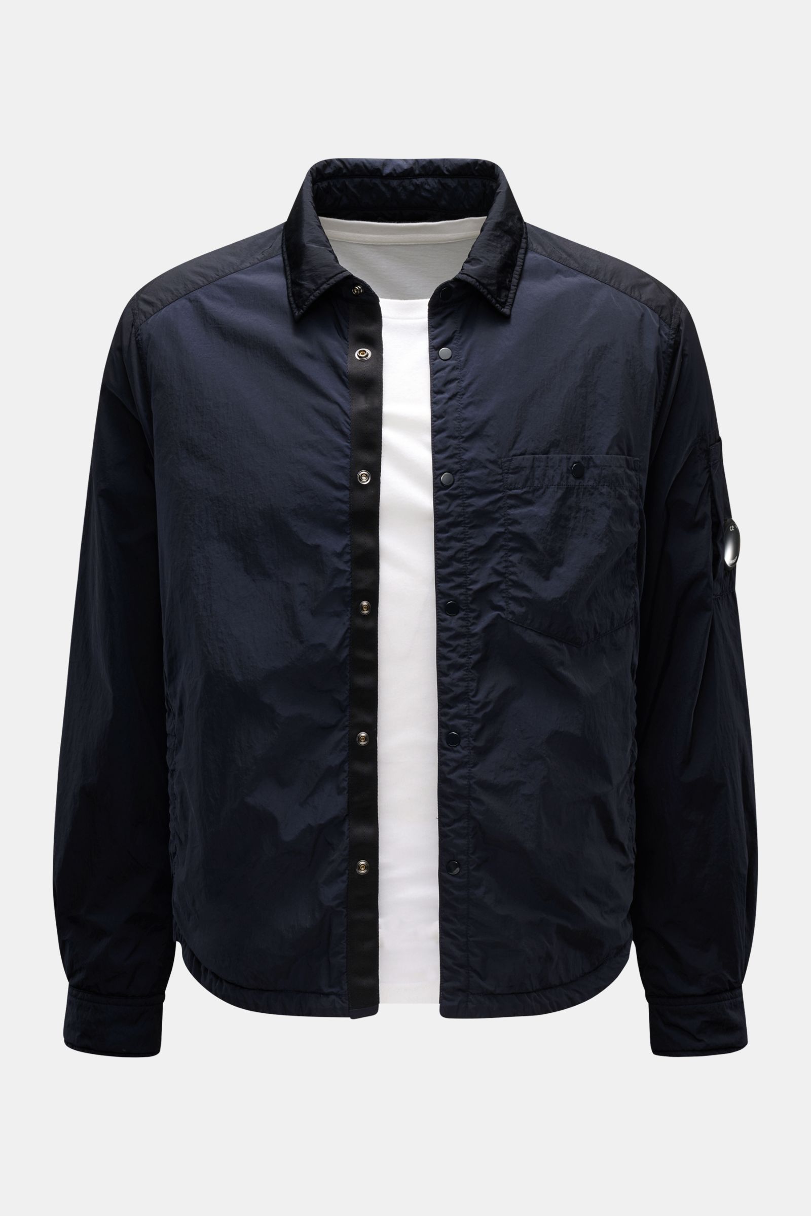 Front view of C.P. Company Overshirt dark navy made of high-quality microfibre, slim fit with snap button placket, turn-down collar, patch breast pocket, side seam pockets, button cuffs, upper sleeve pocket with signature lens detail, smooth lining, insid