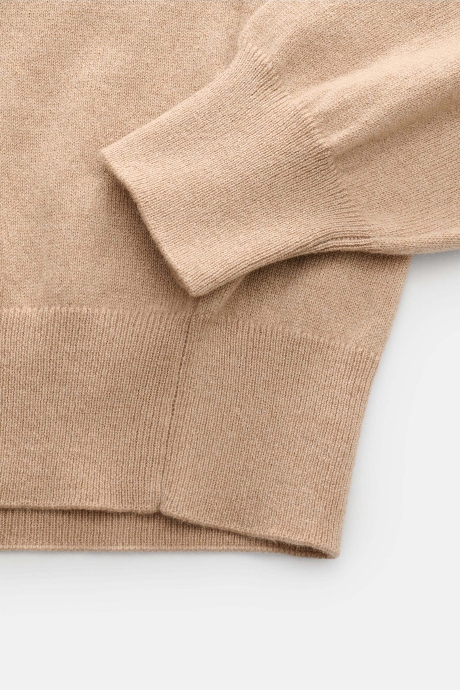 Close-up top-down view of the ribbed cuff and hem of the Cruciani Cashmere V-neck jumper beige, showcasing its fine knit and smooth texture.

This V-neck jumper in pure cashmere by CRUCIANI is the epitome of understatement and style. Its smooth feel an
