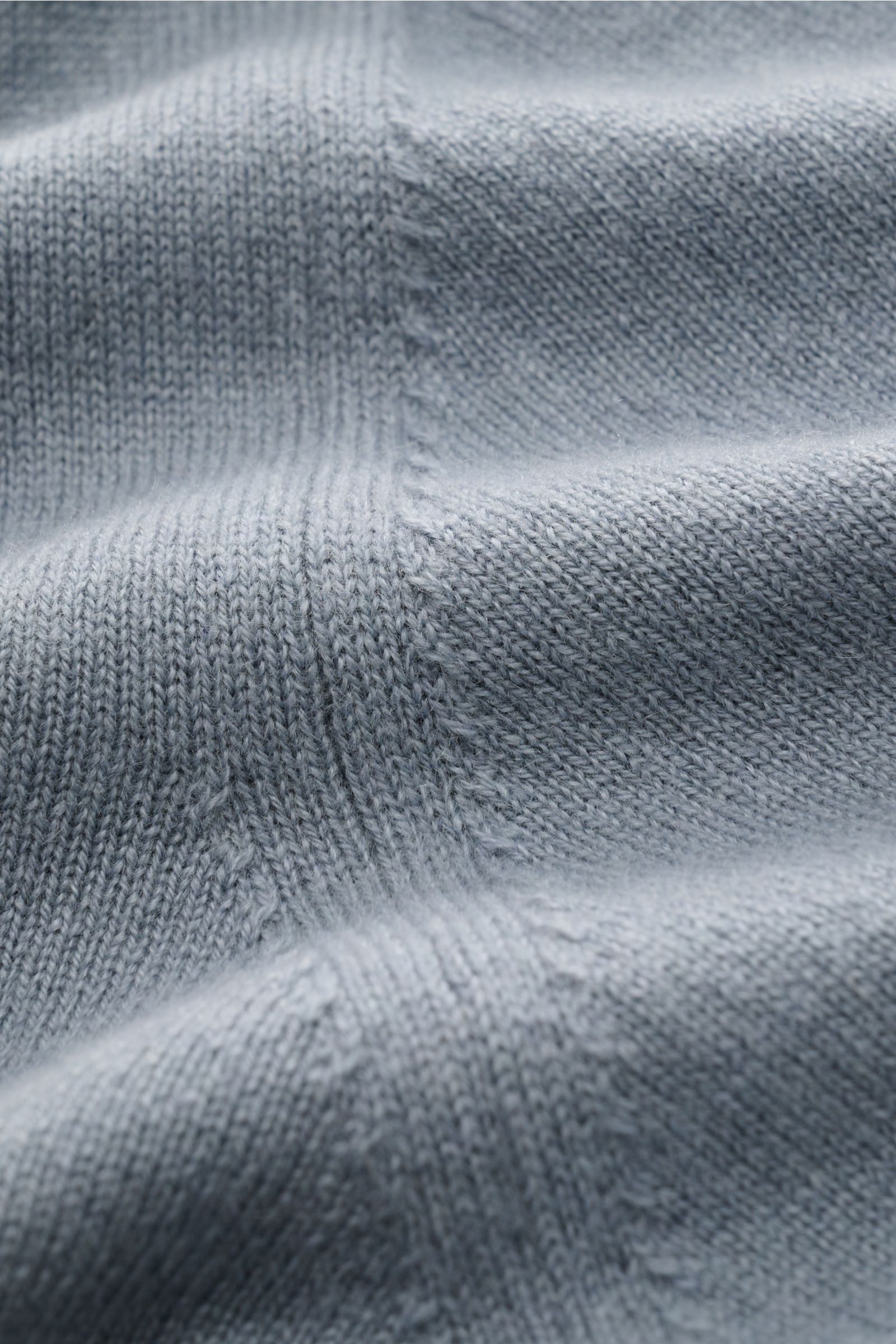 Close-up fabric detail of the Cruciani Cashmere V-neck jumper smoky blue from a top-down perspective, showing fine knit and smooth texture.

This V-neck jumper in pure cashmere by CRUCIANI is the epitome of understatement and style. Its smooth feel and