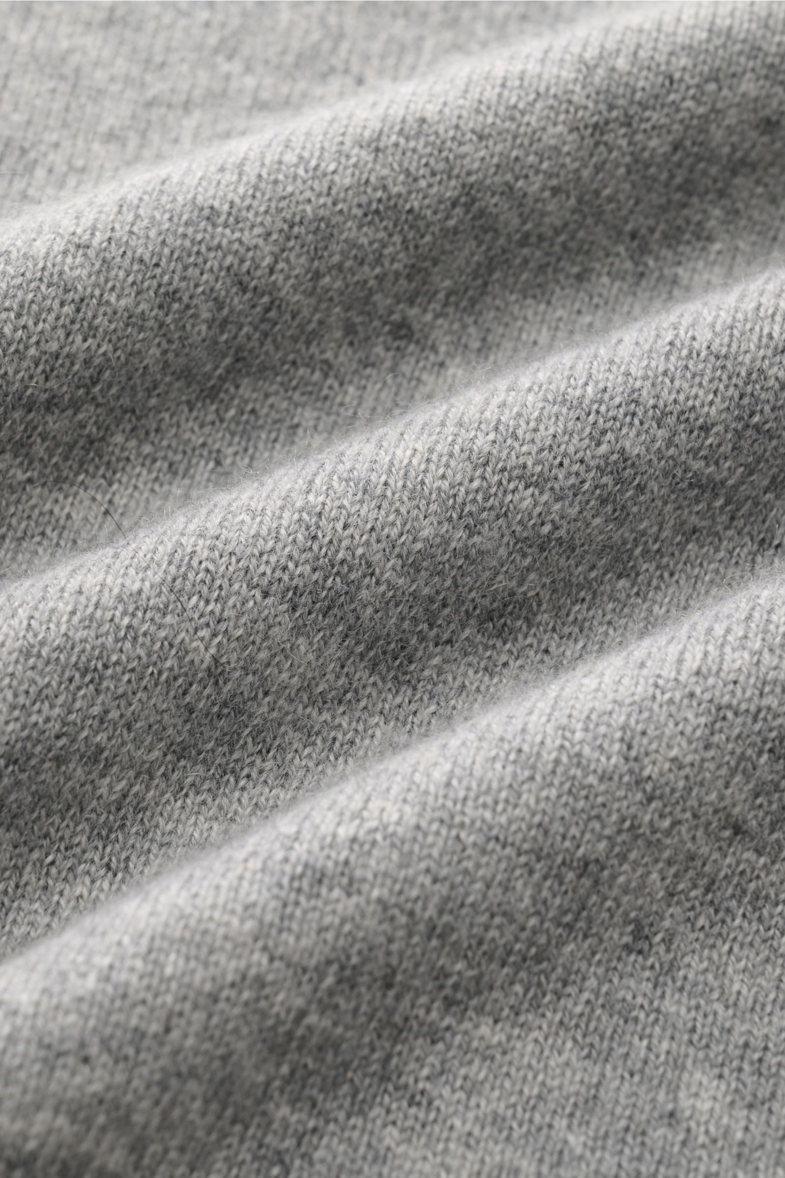 Close-up front view of Cruciani Cashmere V-neck jumper grey mottled showing fine knit texture and smooth touch of pure cashmere fabric.

Description: This V-neck jumper in pure cashmere by CRUCIANI is the epitome of understatement and style. Its smooth