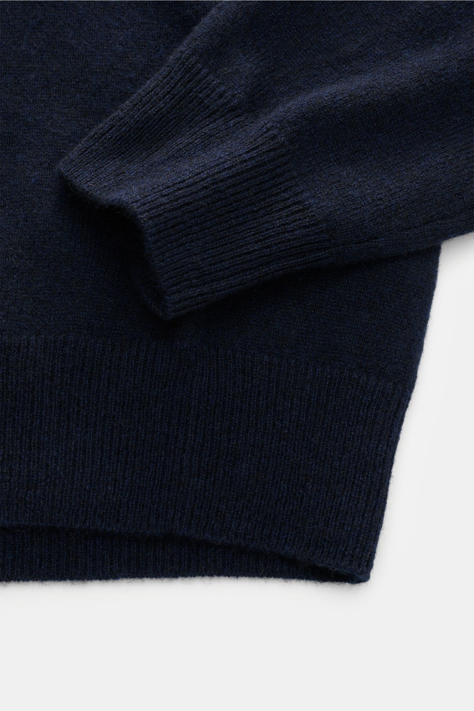 Close-up front view of the navy FTC Cashmere V-Neck Pullover sleeve and ribbed hem, made from soft, fair-trade cashmere.

Description: Der Pullover mit V-Ausschnitt ist ein Klassiker der Herrenmode, der in keinem Kleiderschrank fehlen darf – aus nachha