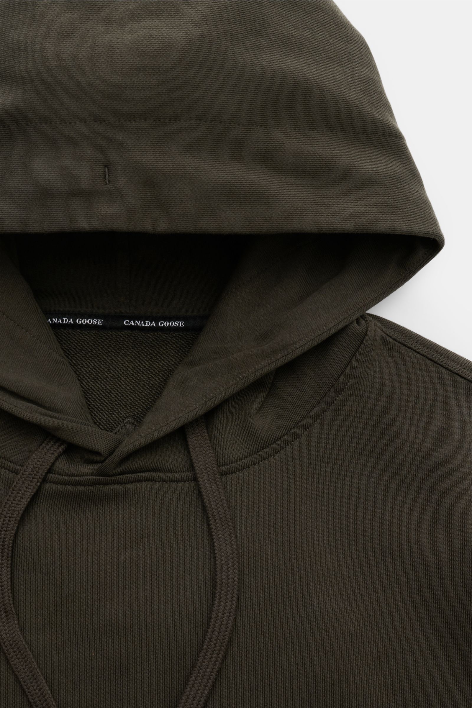 Close-up front view of the Canada Goose Kapuzenpullover 'Huron' beige hoodie showing hood, drawstrings, and stitching details.

Urbaner Style trifft Komfort – der Kapuzenpullover 'Huron' von CANADA GOOSE verbindet angenehmen Tragekomfort mit einem spor