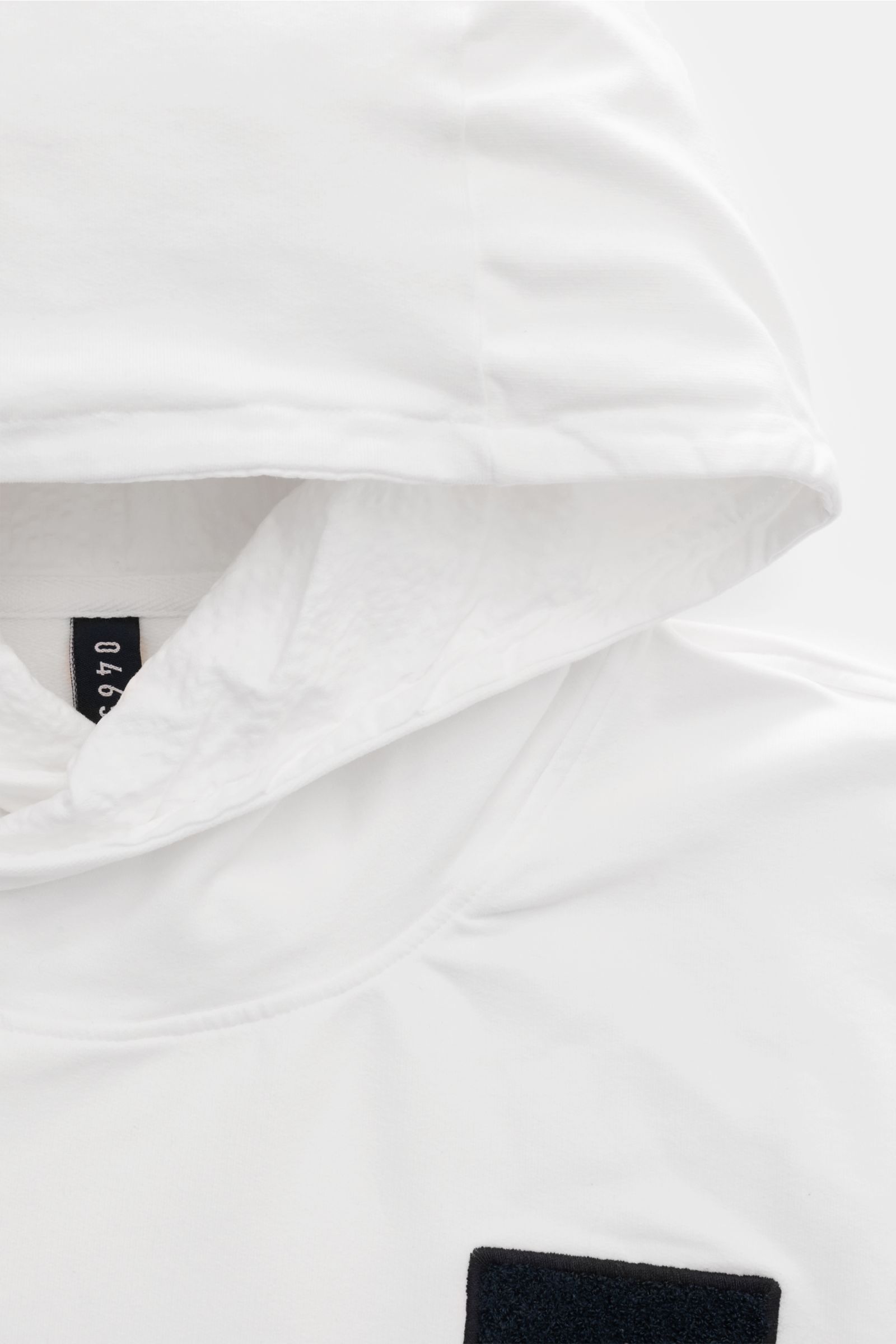 Close-up front view of 04651/ A trip in a bag Kapuzenpullover 'IF Hoodie' offwhite made of brushed elastic cotton jersey with soft feel, practical hood, ribbed cuffs, and small side seam web label.