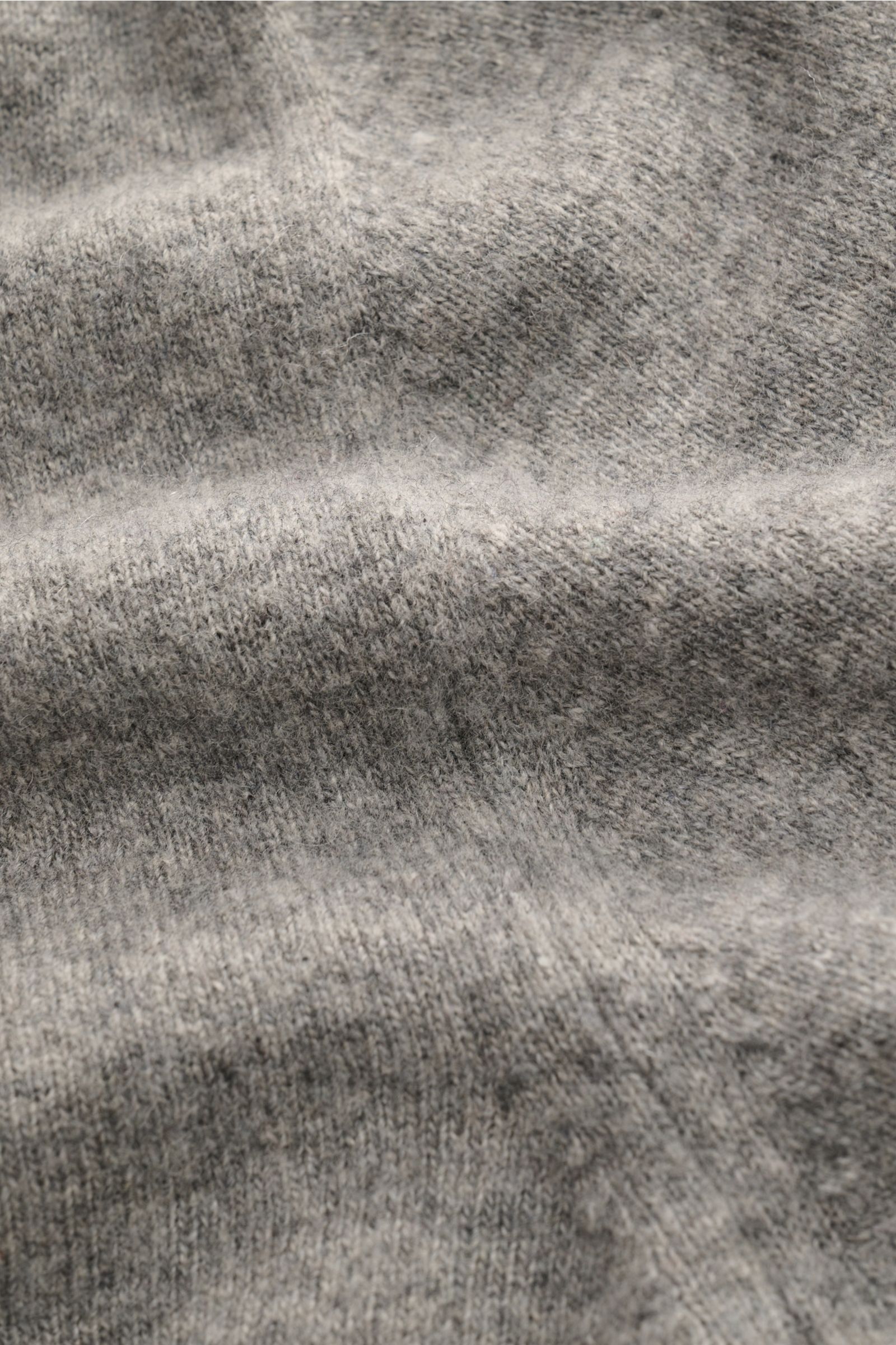 Close-up front view of the 04651/ A trip in a bag Kapuzenpullover sand showing soft wool, cashmere, and viscose knit with fine stitch, slim fit, knitted hood, and comfortable ribbed cuffs.