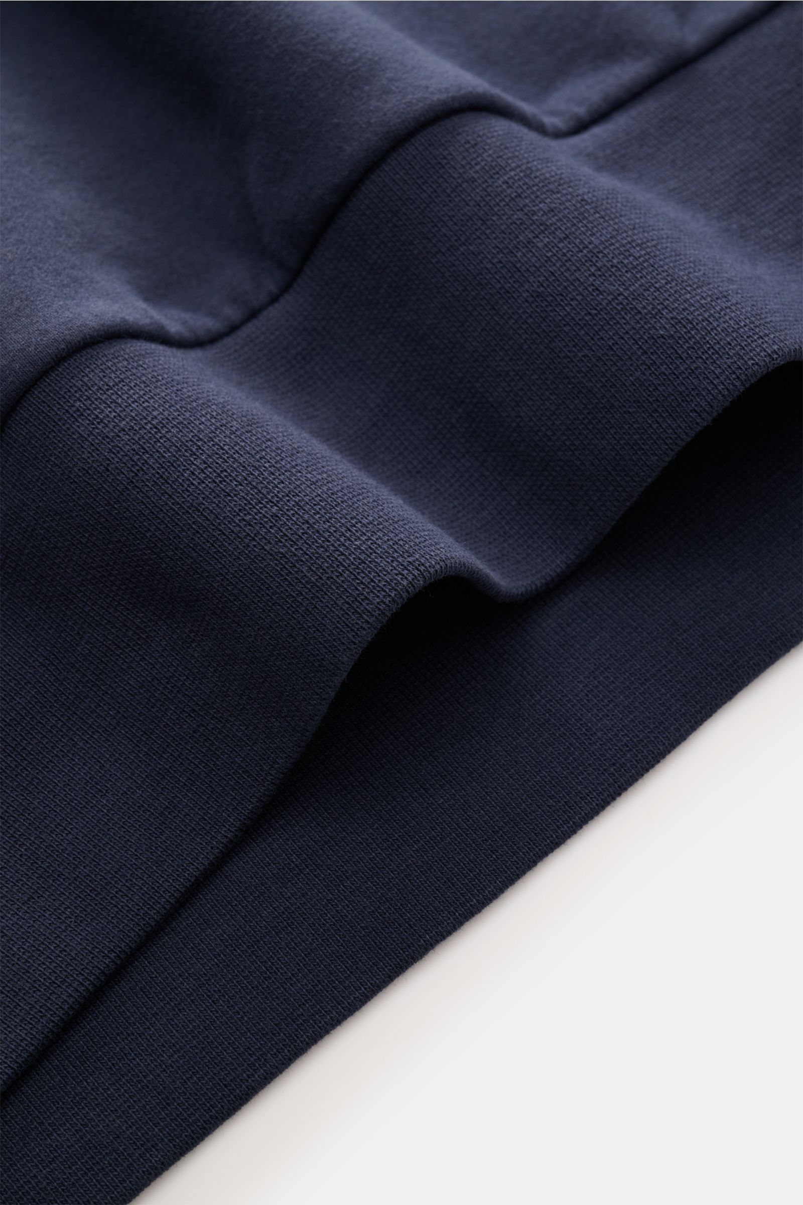 Close-up side view of the ribbed bands on the dark blue 04651/ A trip in a bag Hooded jumper 'IF Hoodie' made of stretchy brushed cotton jersey.